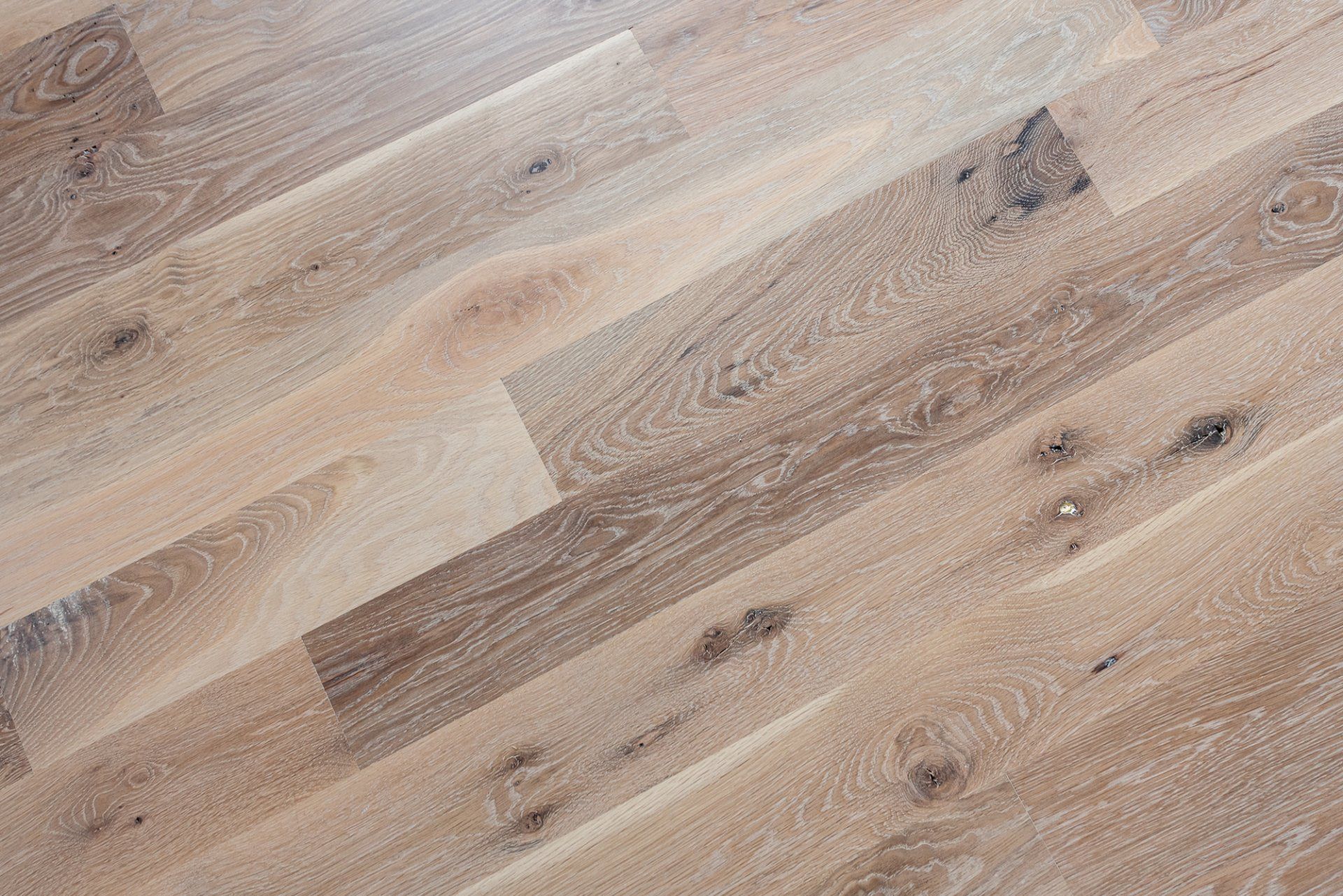 A close up of a wooden floor with a diagonal pattern.