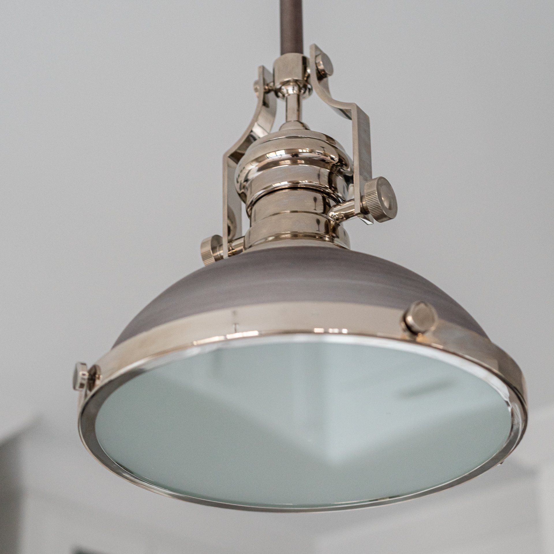 A pendant light with a clear glass shade is hanging from the ceiling