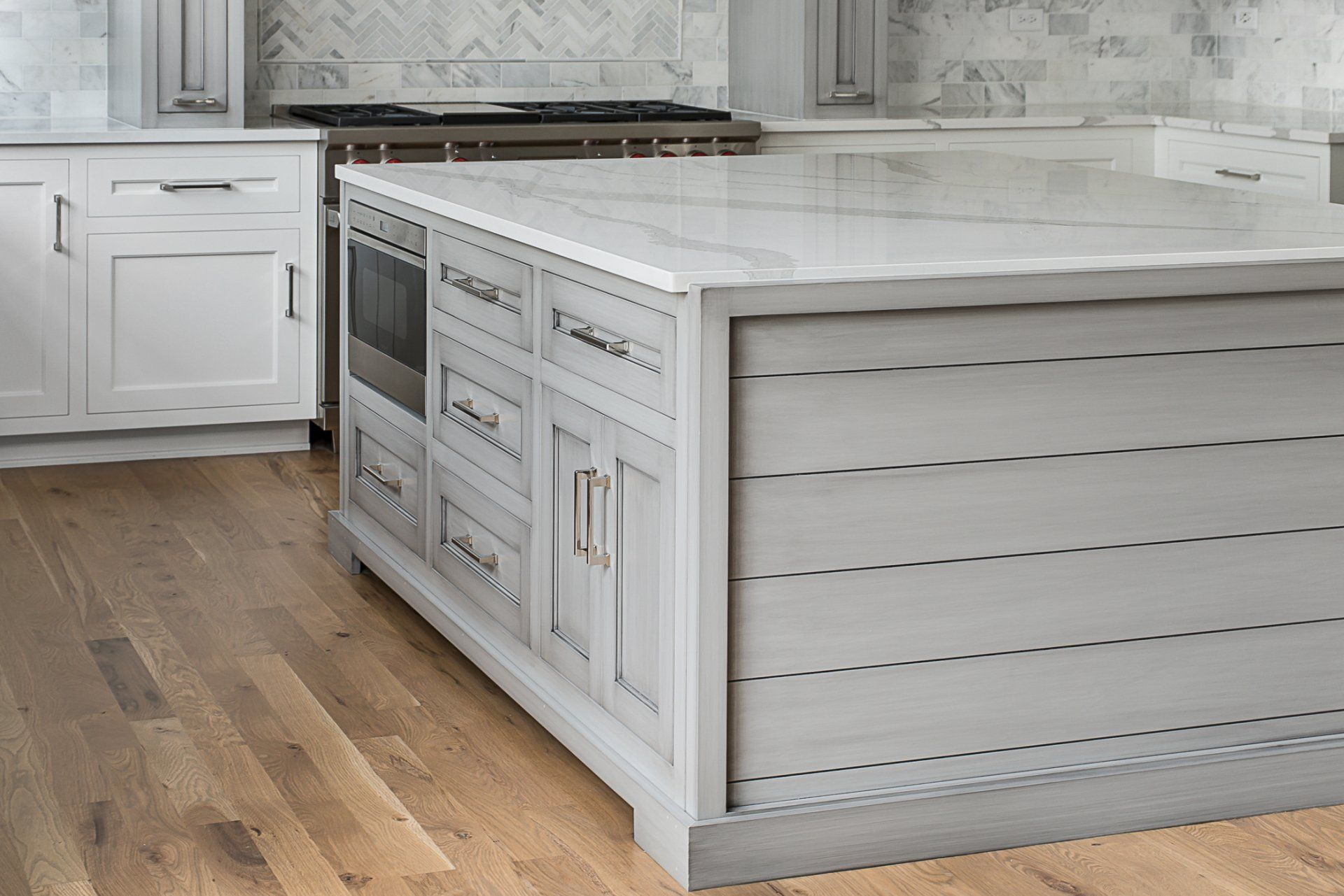 There is a large island in the middle of the kitchen.