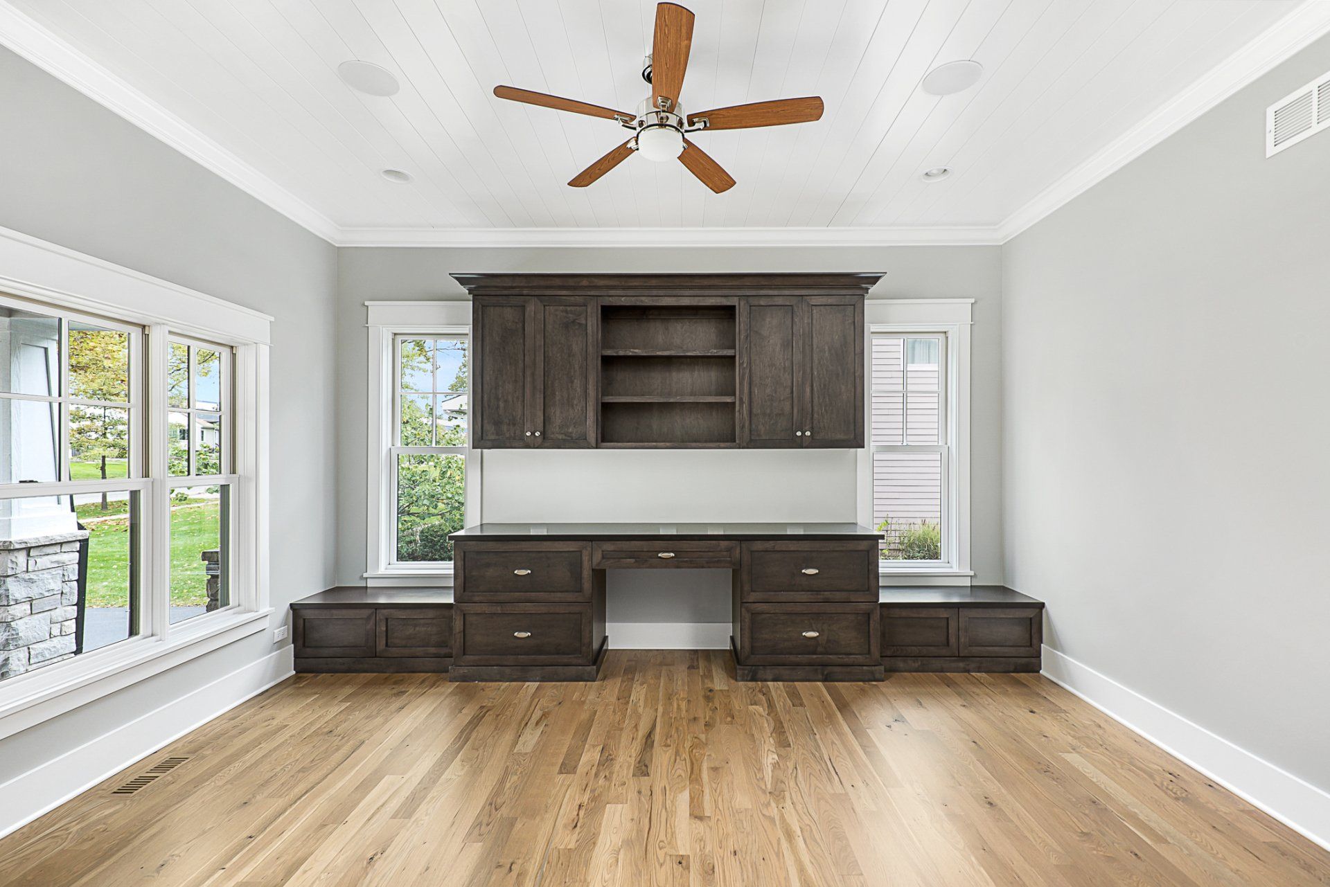 There is a ceiling fan in the corner of the room.