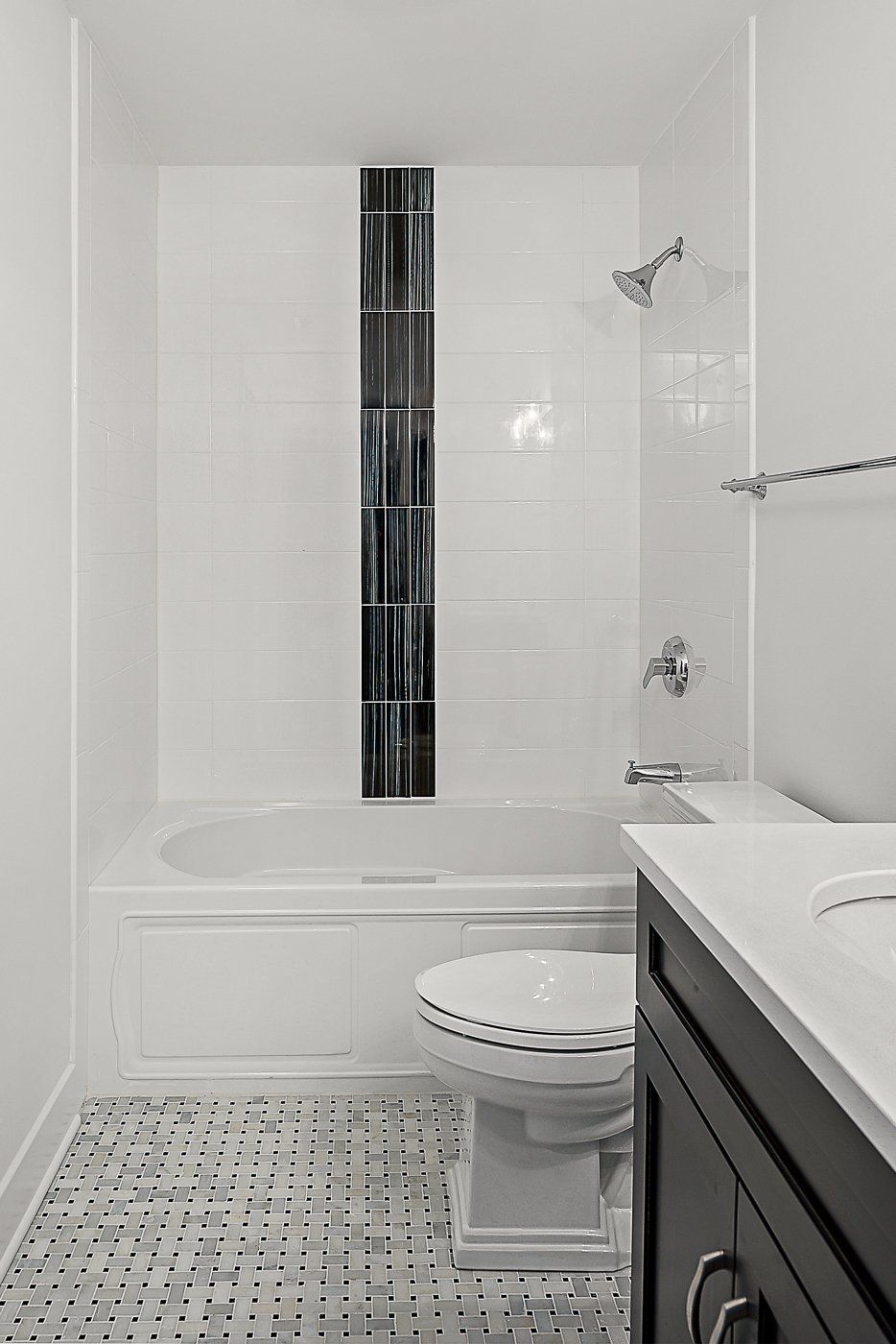 A bathroom with a toilet , sink , bathtub and shower.