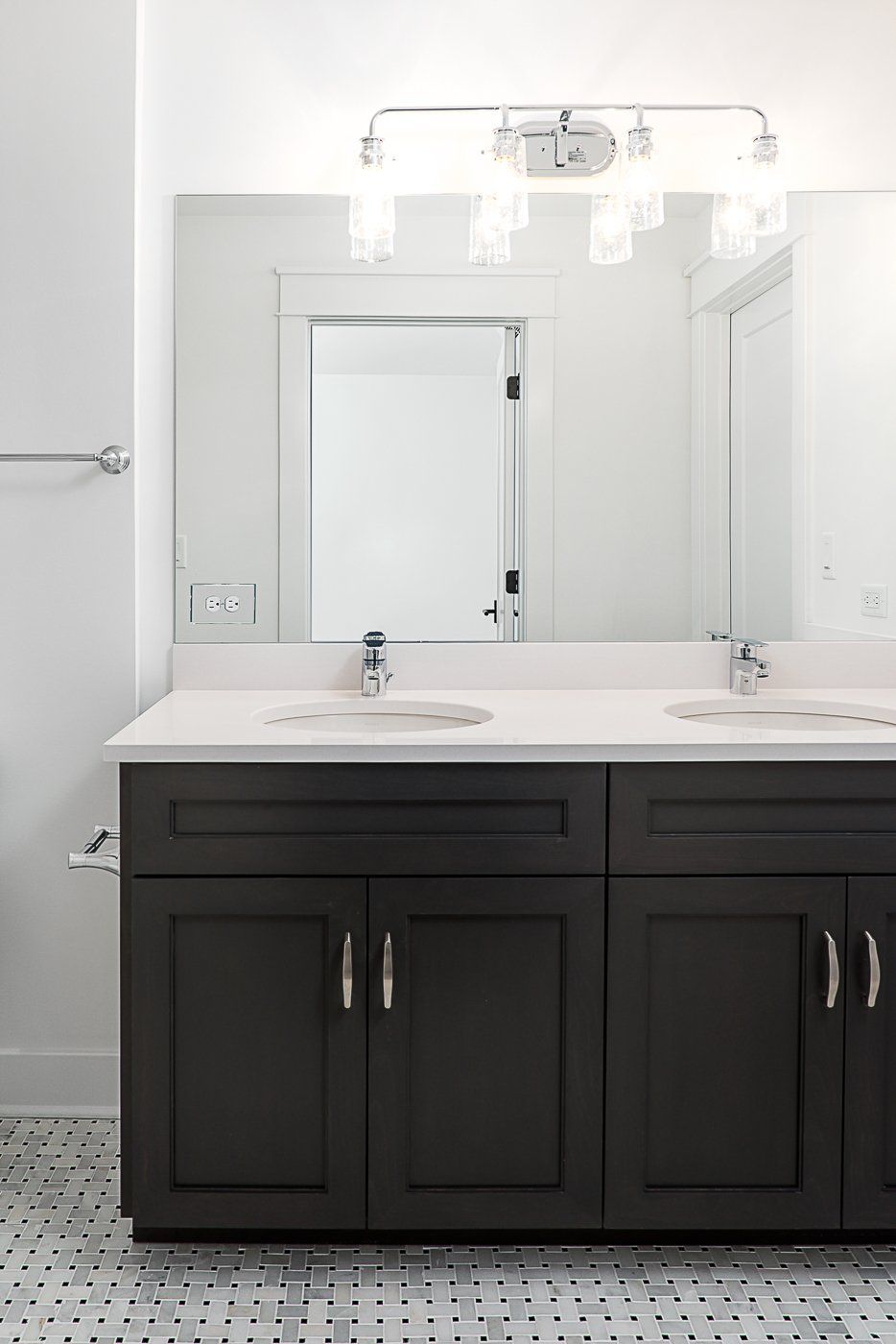 A bathroom with two sinks and a mirror.