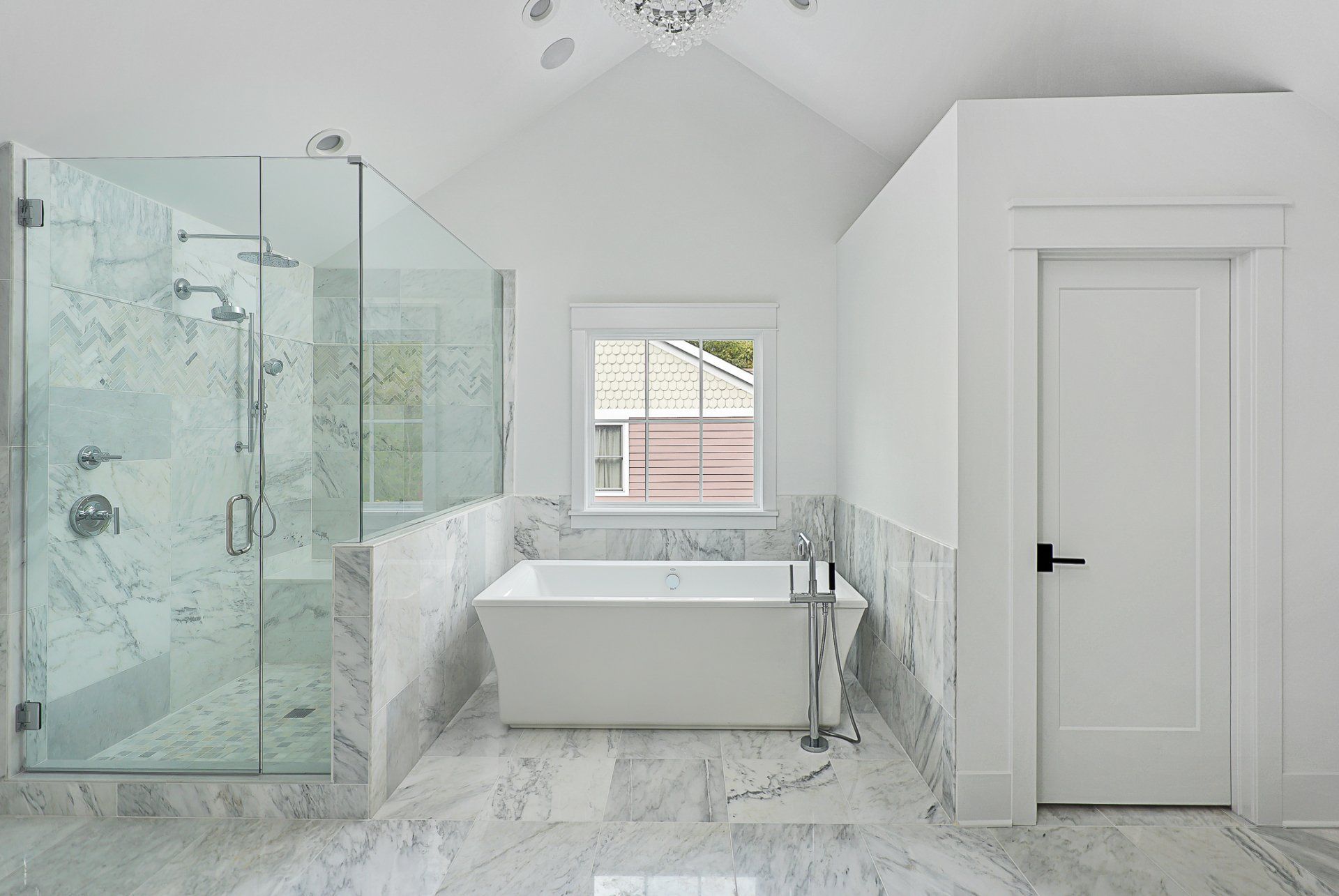 A bathroom with a bathtub , shower , and window.