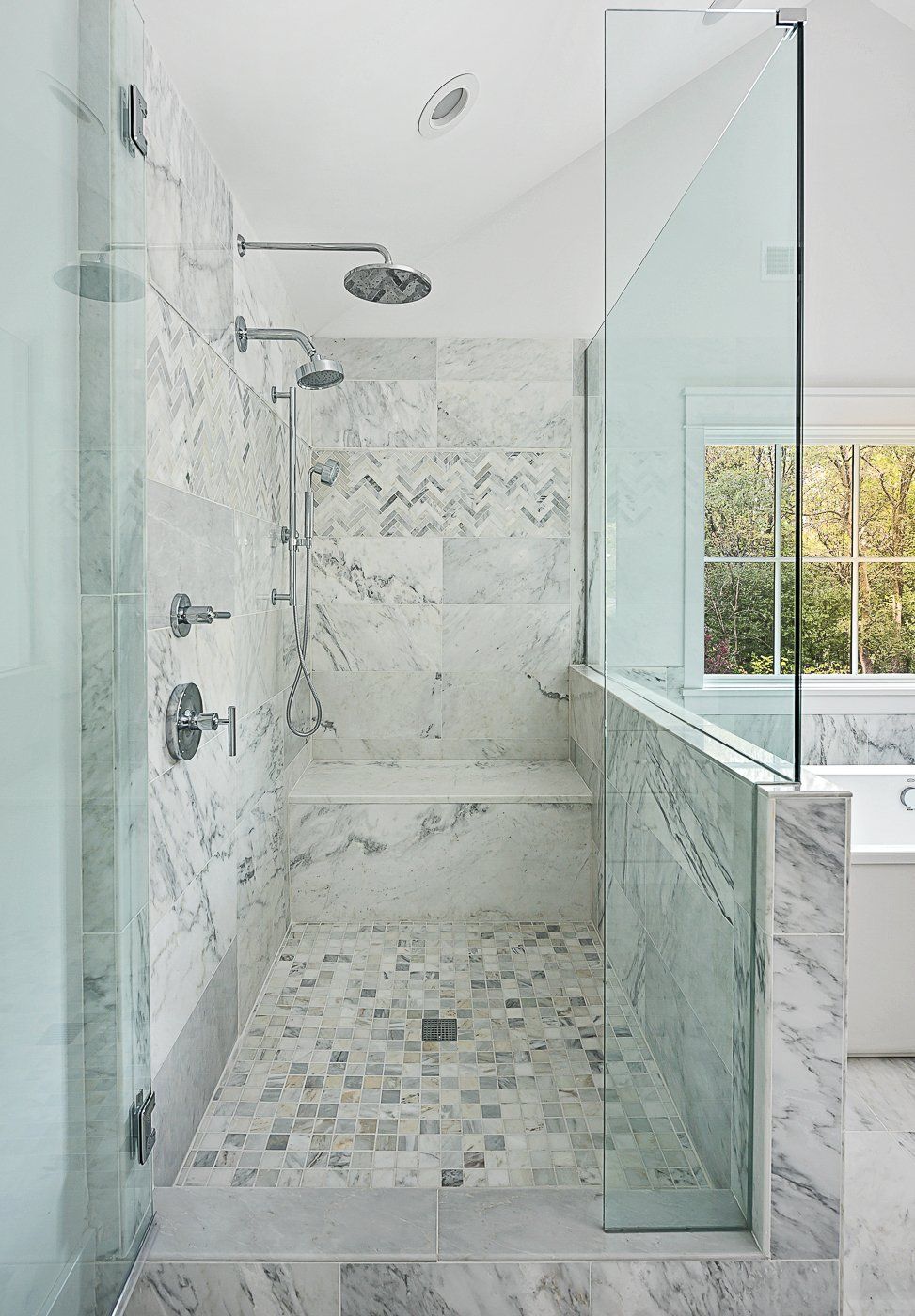 A bathroom with a walk in shower and a bathtub.