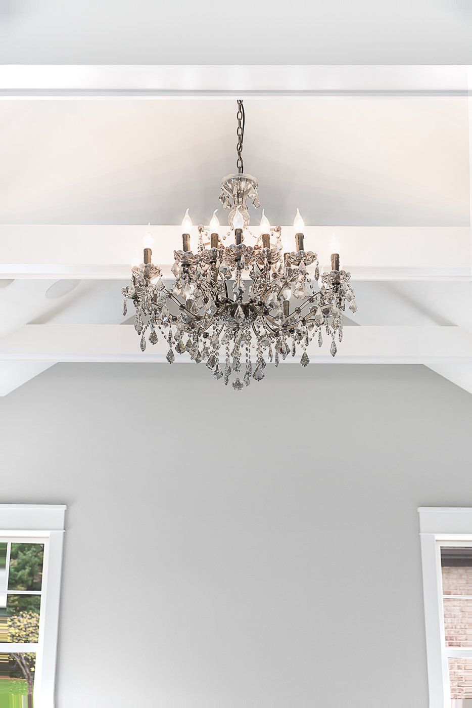 A large chandelier is hanging from the ceiling of a room.