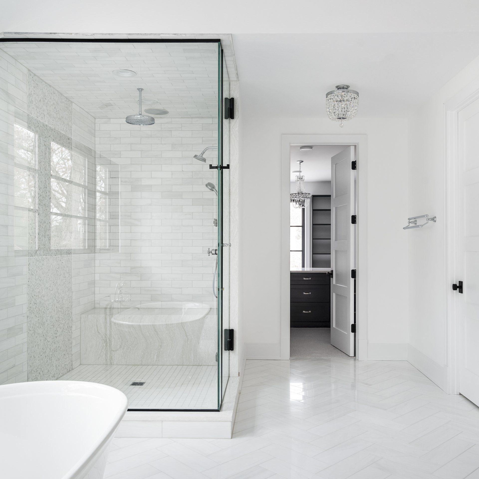 A bathroom with a walk in shower and a bathtub.