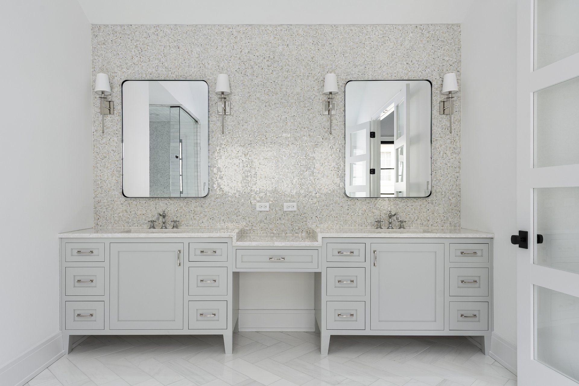 A bathroom with two sinks and two mirrors.