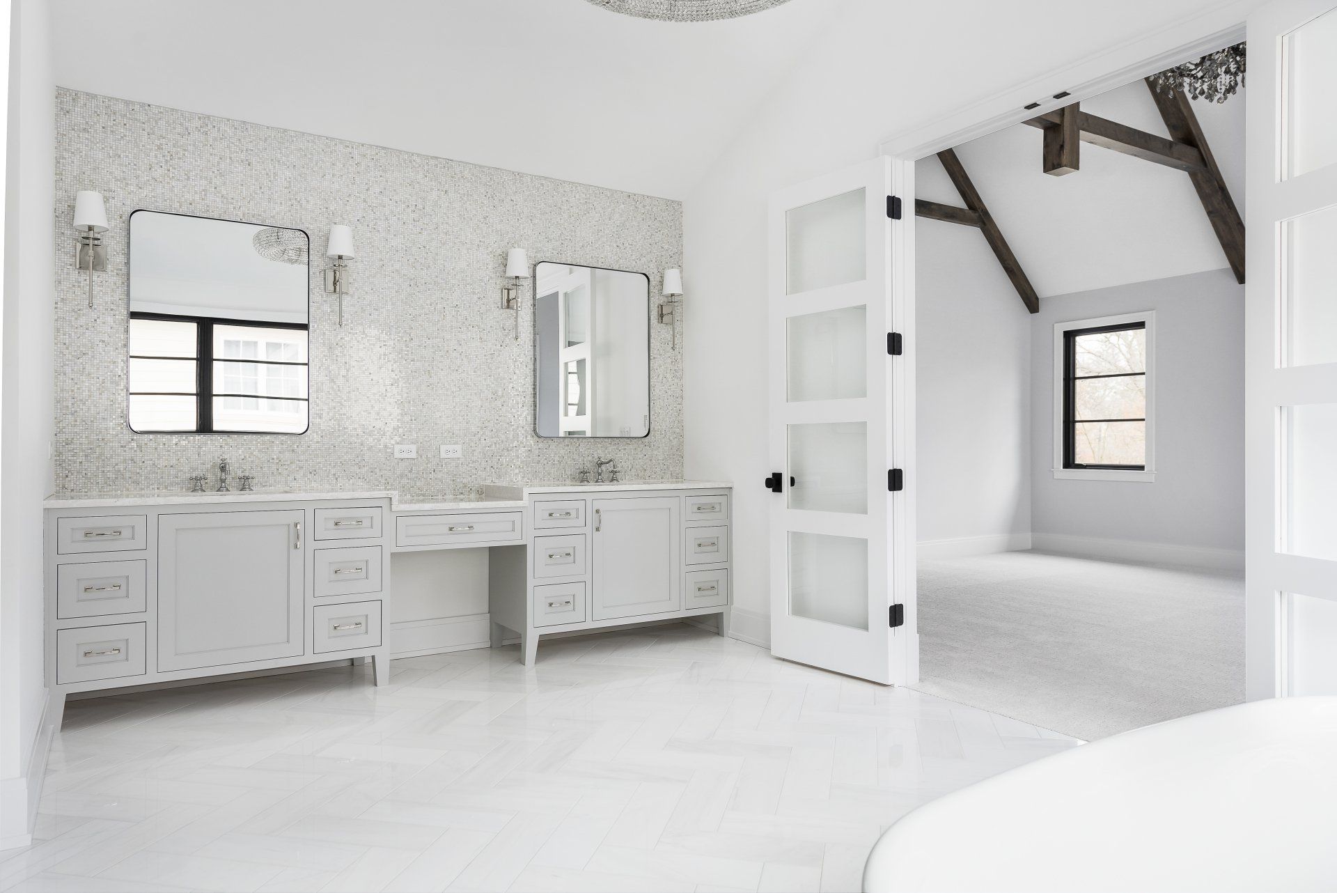 A bathroom with two sinks , two mirrors and a tub.