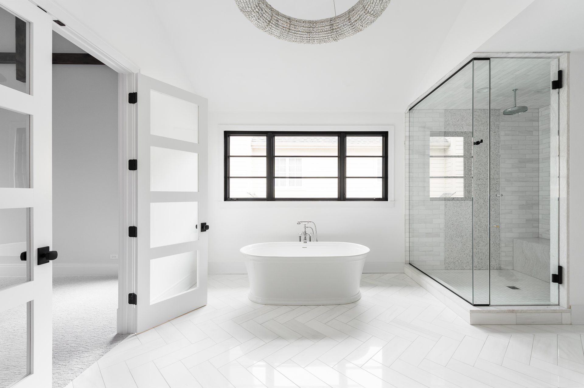 A bathroom with a bathtub , shower , and window.