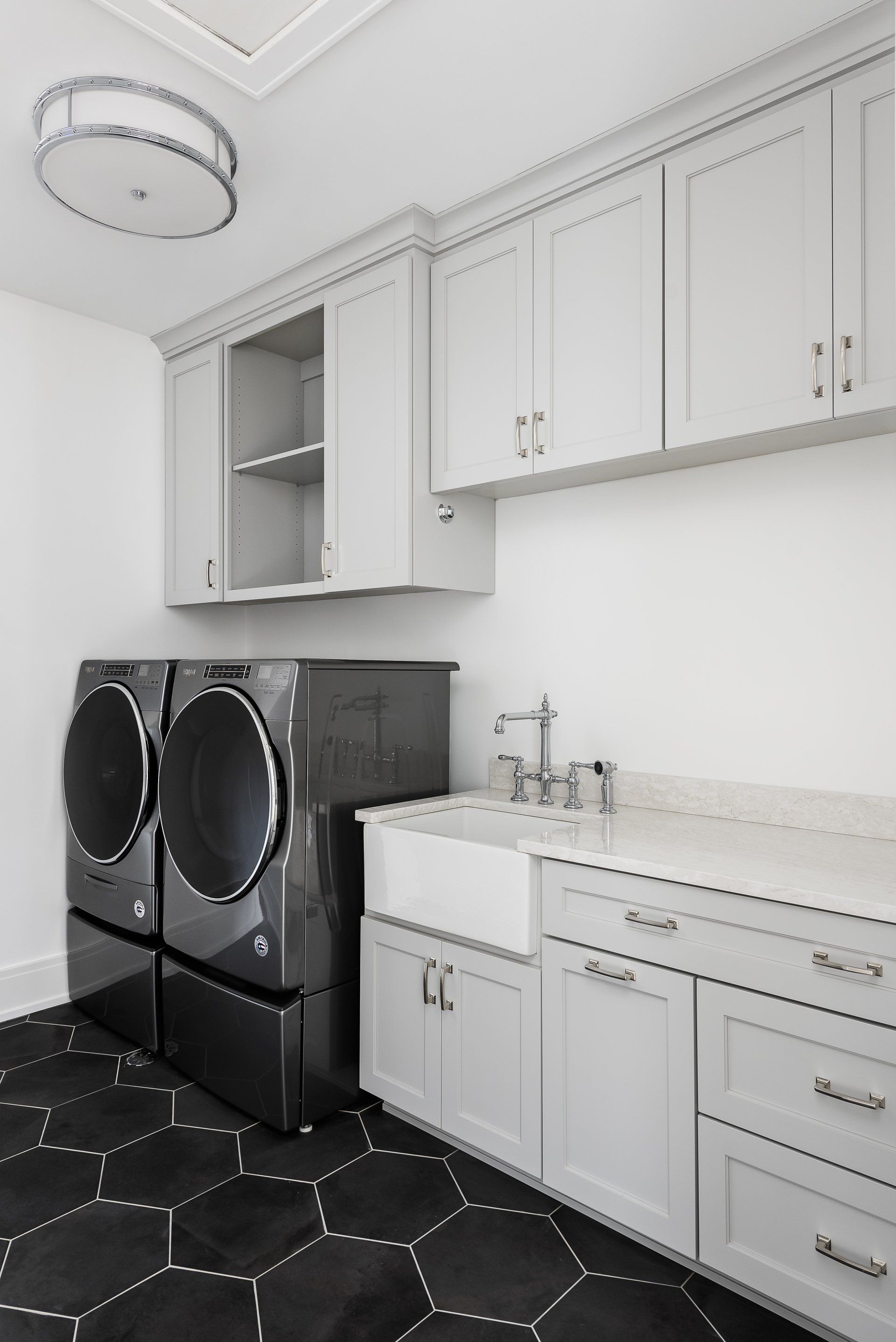 A laundry room with a washer and dryer and a sink