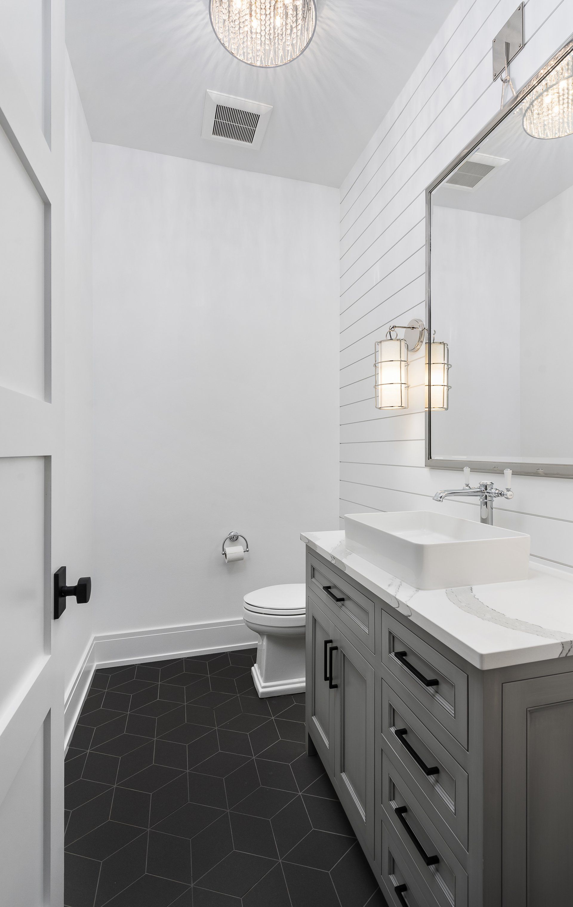 A bathroom with a sink , toilet and mirror.