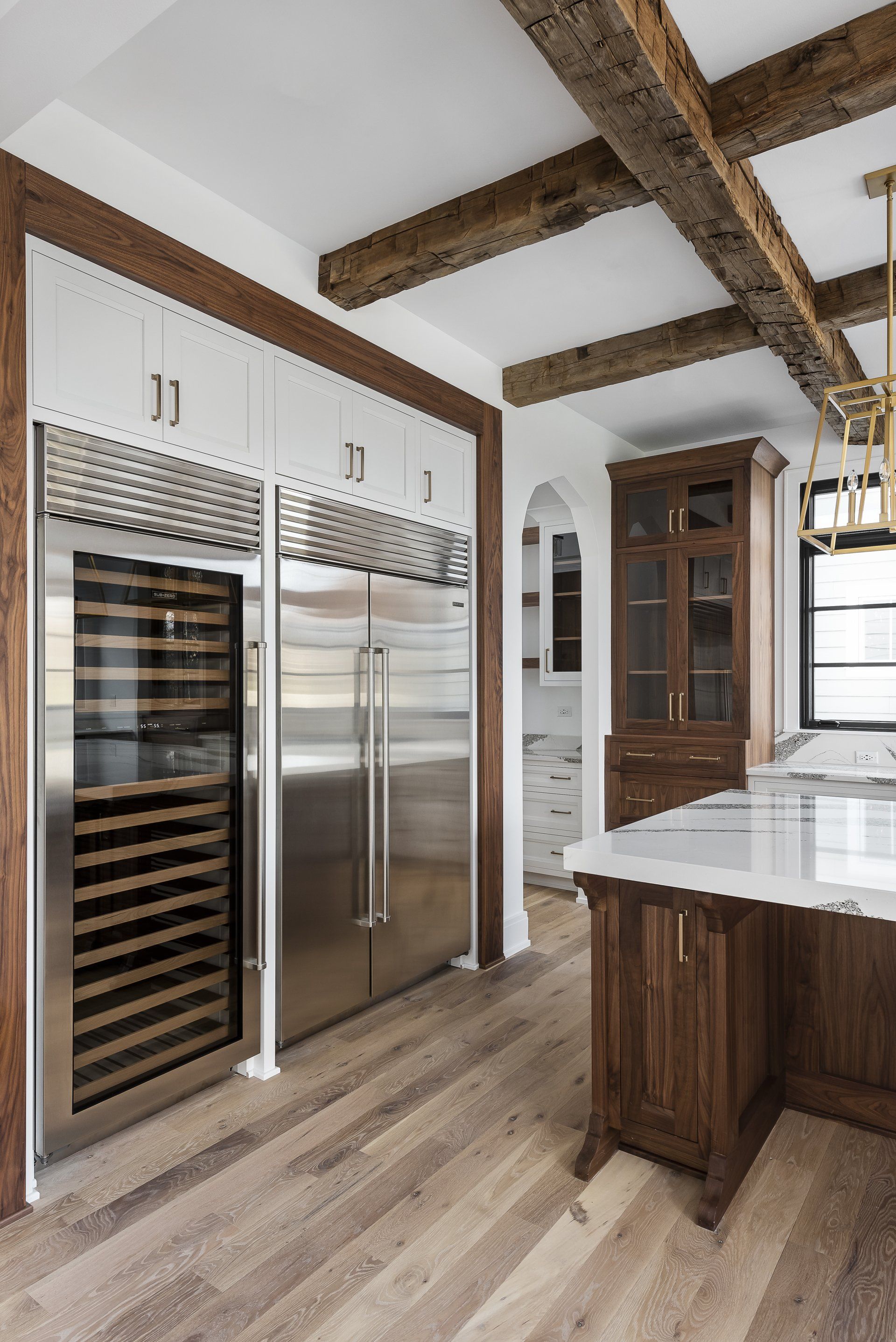 A kitchen with stainless steel appliances and wooden cabinets.