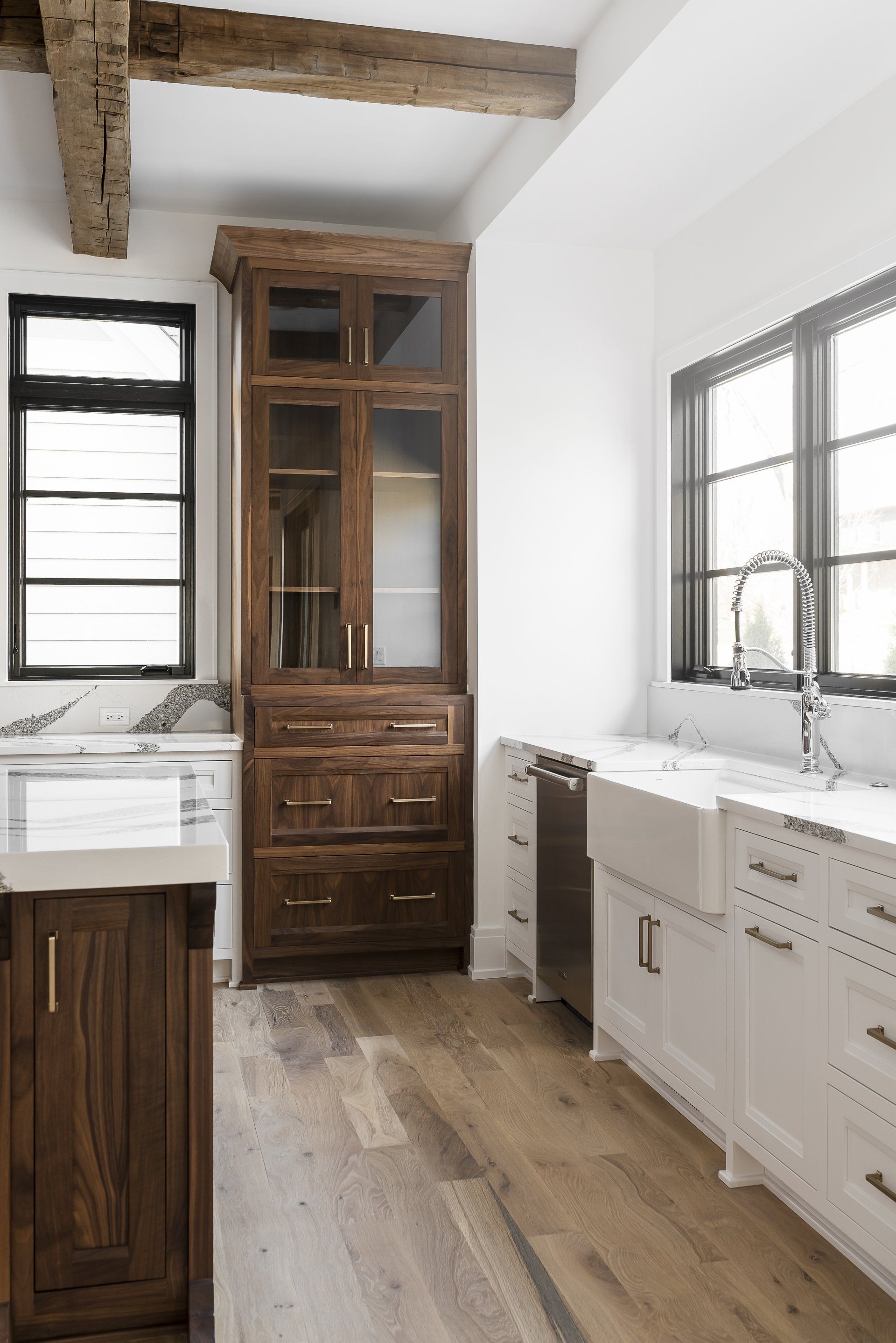 A kitchen with a sink , cabinets , drawers and a hutch.