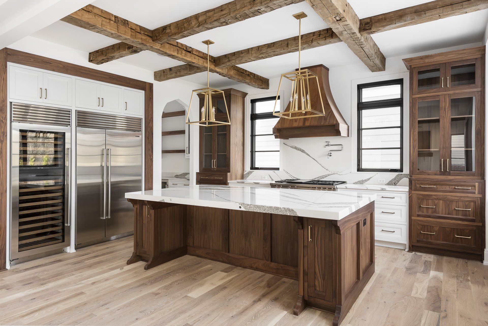 A kitchen with a large island and stainless steel appliances.