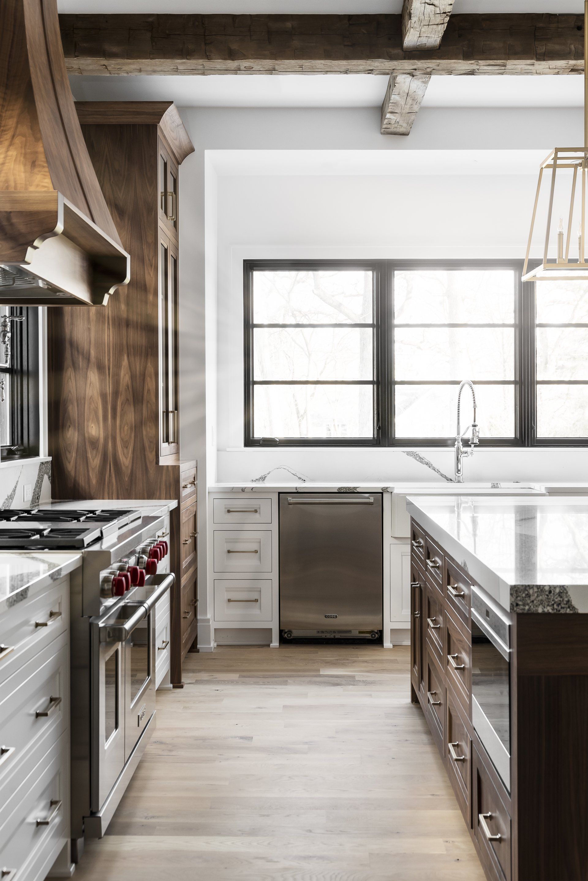 A kitchen with stainless steel appliances , wooden cabinets , and a large island.