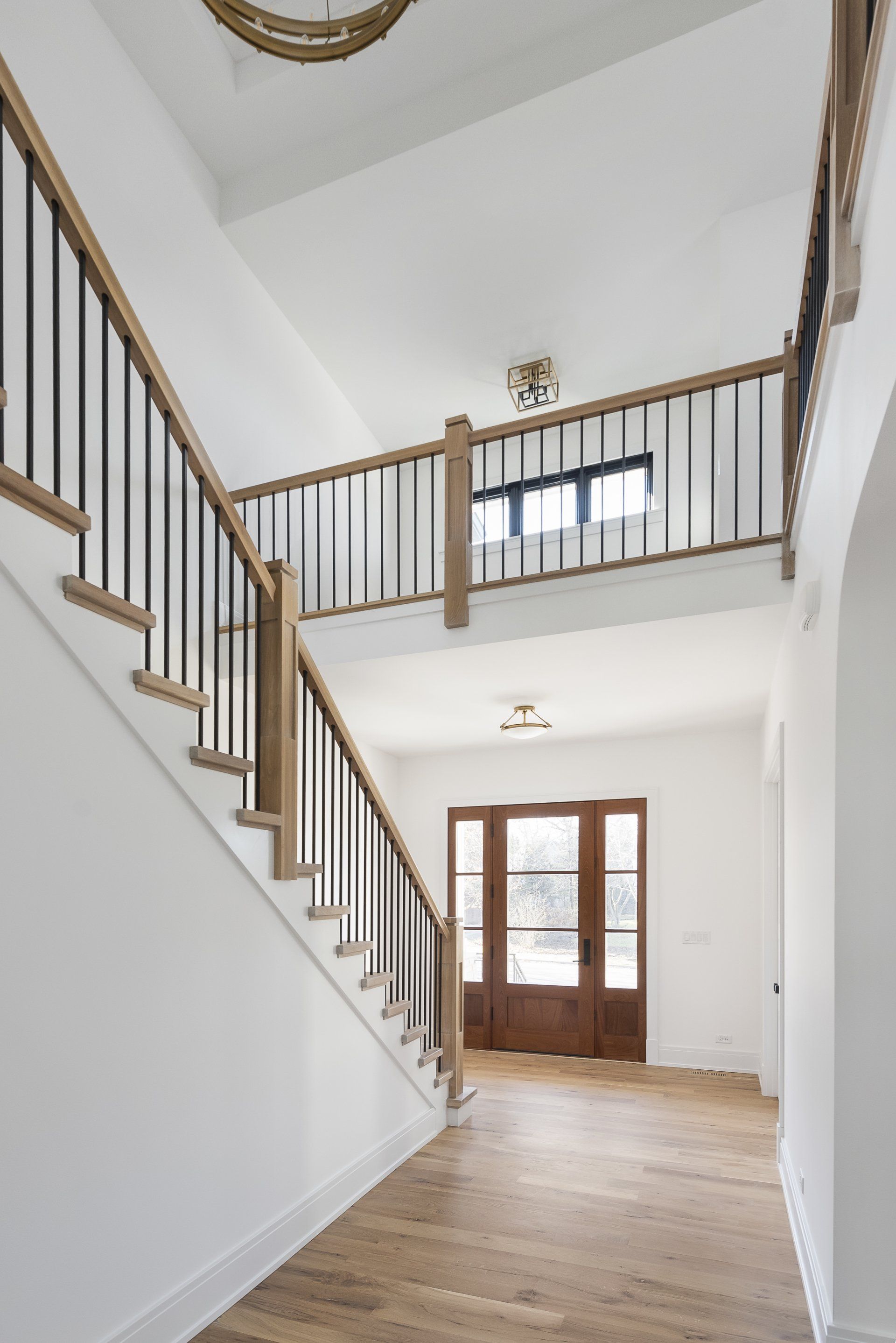 A hallway with stairs leading up to the second floor of a house.