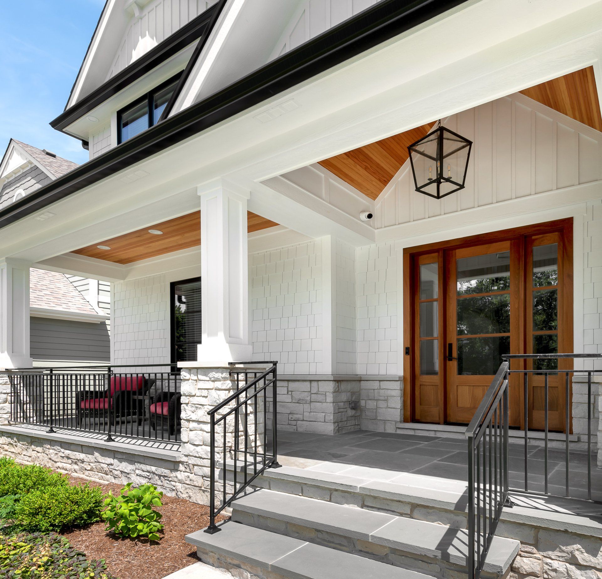 A large white house with a porch and stairs