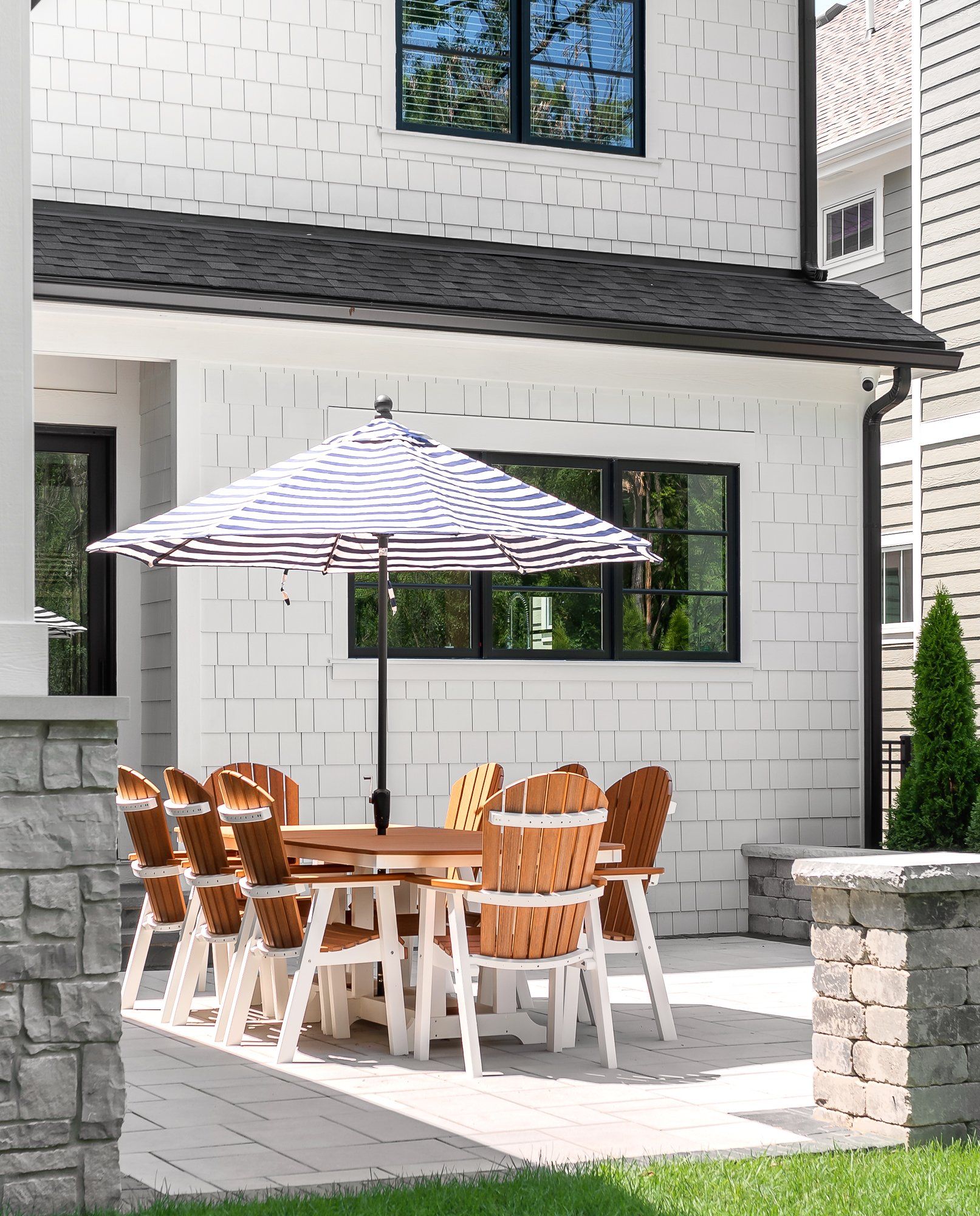A patio with a table and chairs under an umbrella
