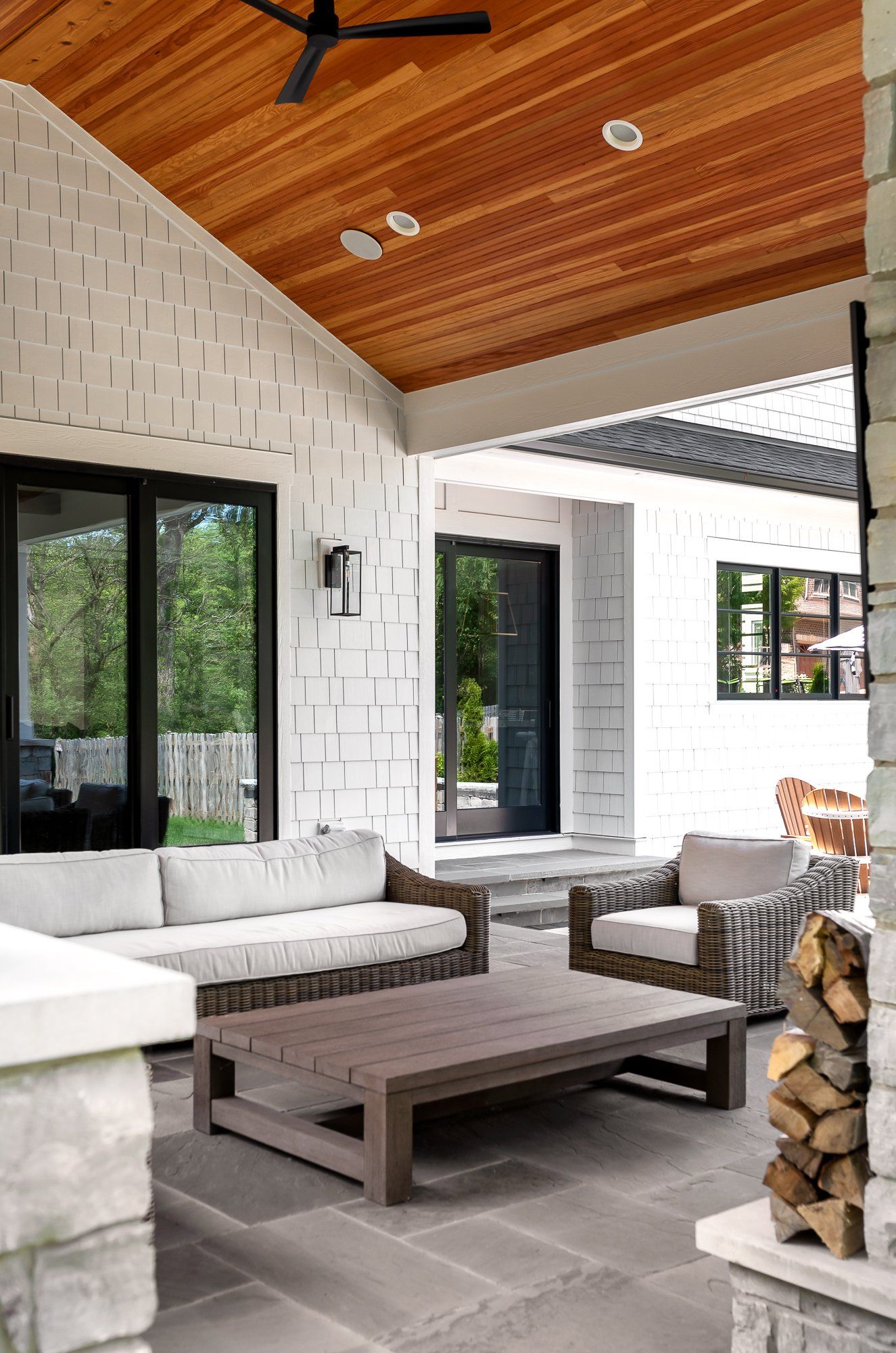 A living room with a lot of furniture and a ceiling fan.