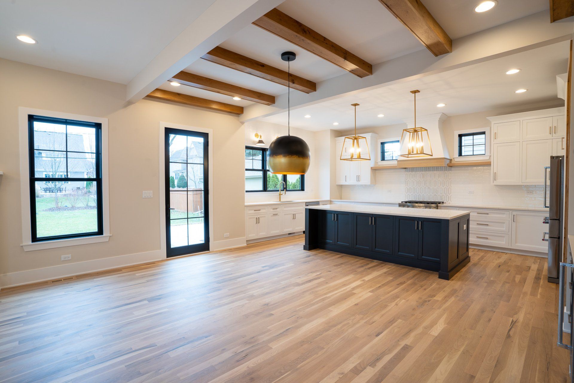 An empty kitchen with a large island in the middle of the room.