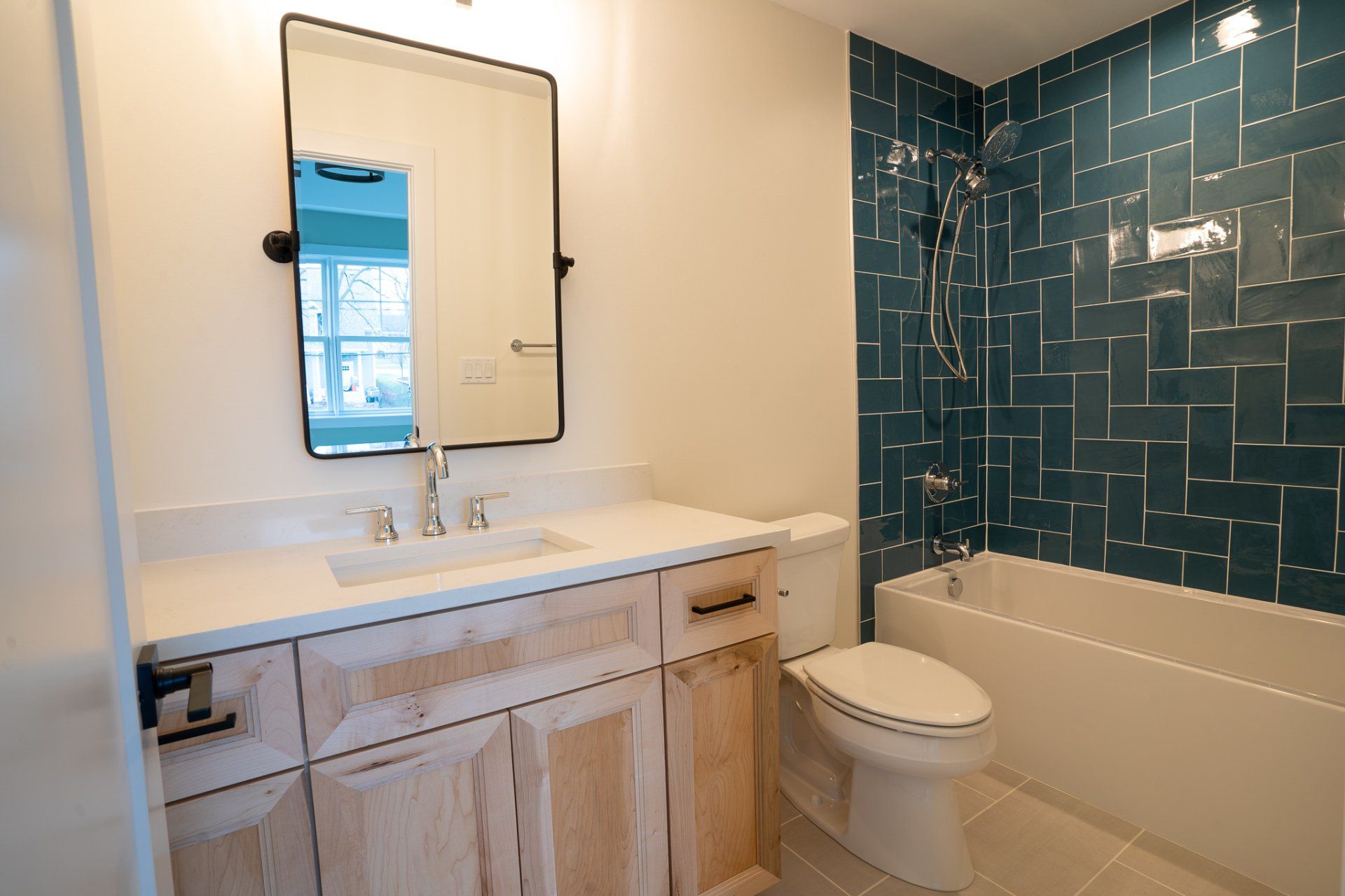A bathroom with a sink , toilet , tub and mirror.