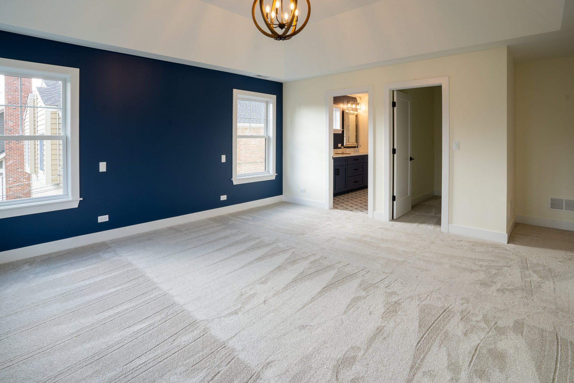 An empty room with blue walls and white carpet