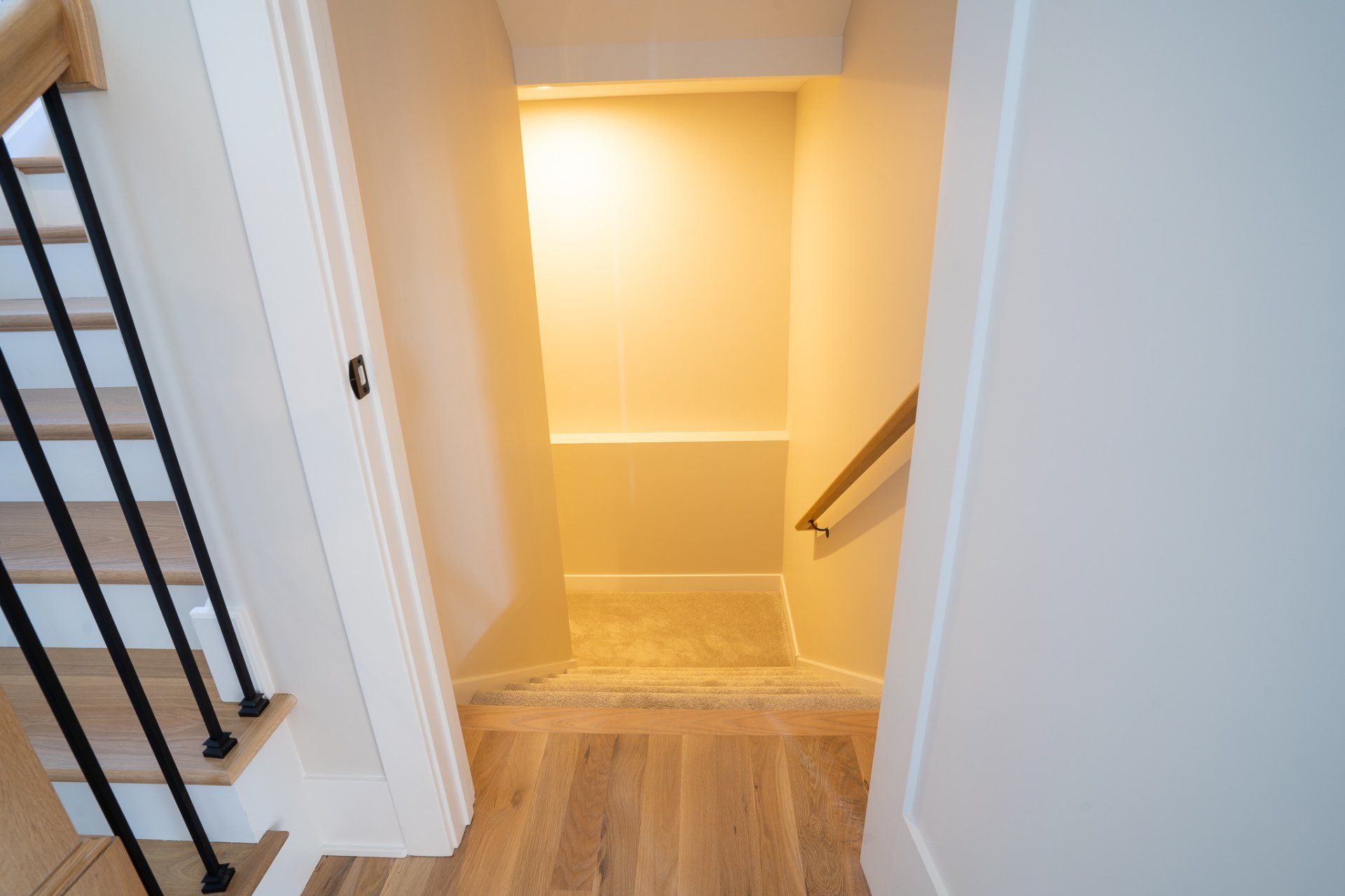 A staircase leading up to a closet in a house.
