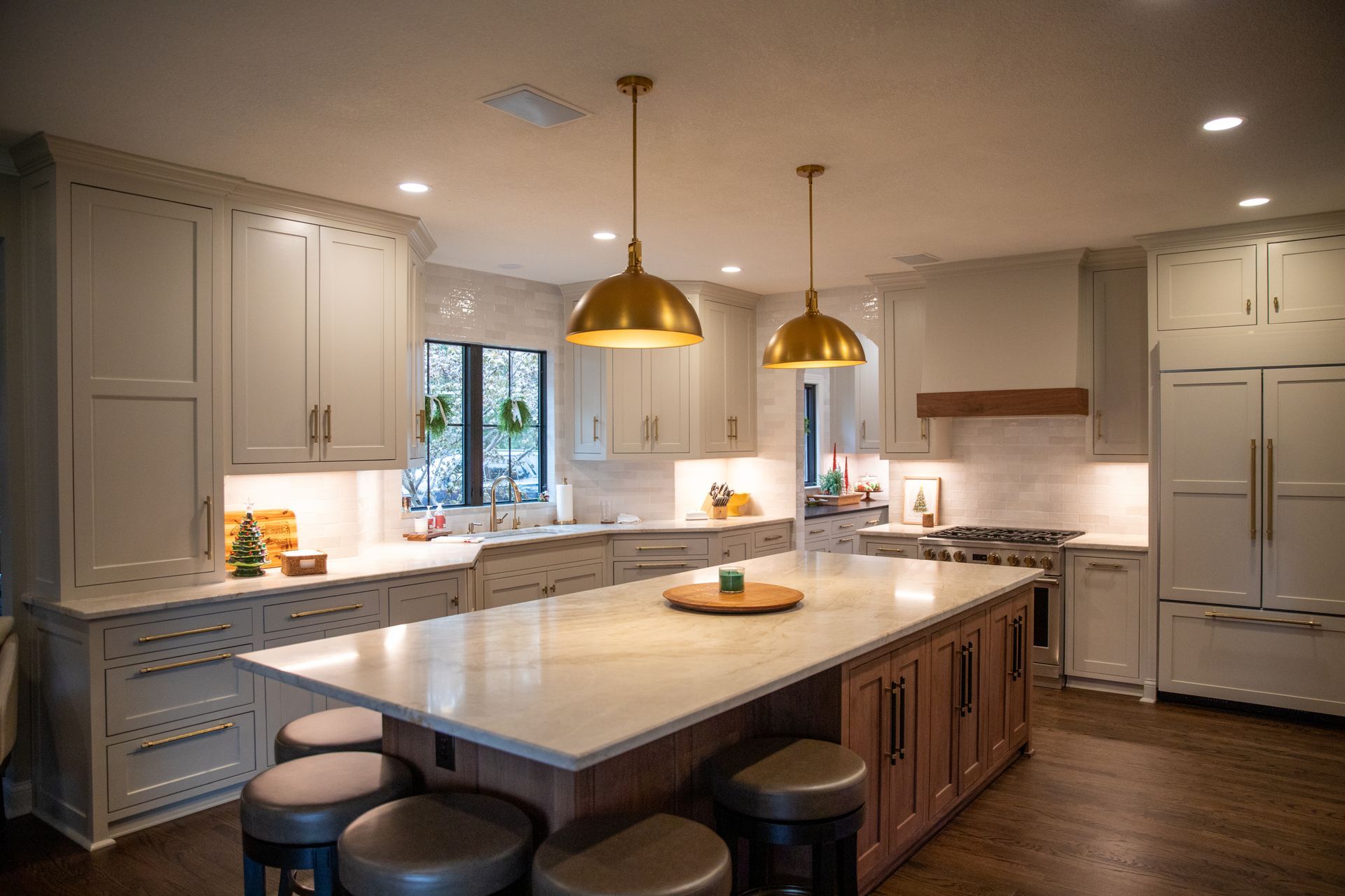 Kitchen under construction with white cabinets, bare countertops, and a window.