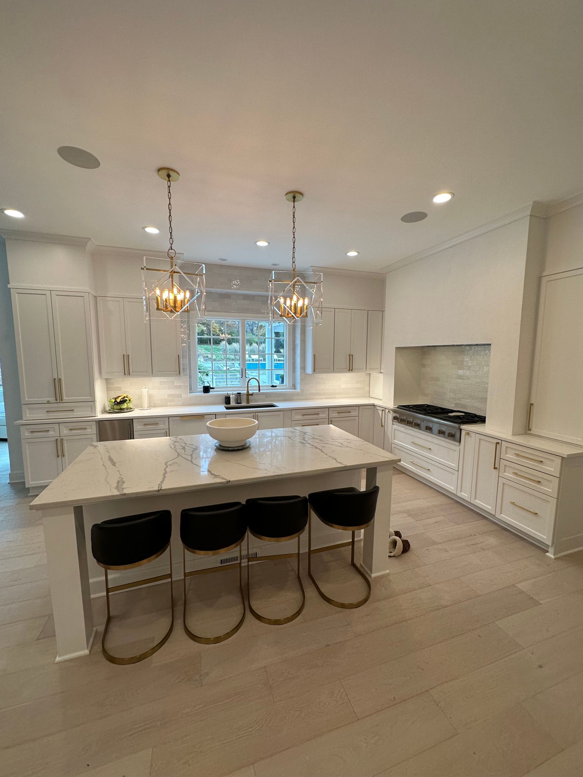 A room under construction with white walls, unfinished flooring, construction tools, and a wooden plank.