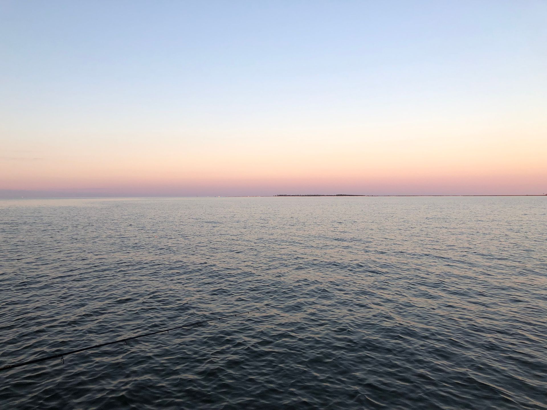 A large body of water with a sunset in the background