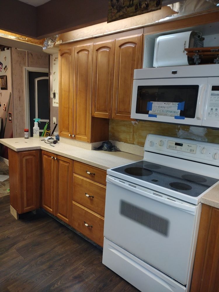 Handyman carefully installing floor tiles in a room, ensuring precise alignment and leveling for a professional finish.