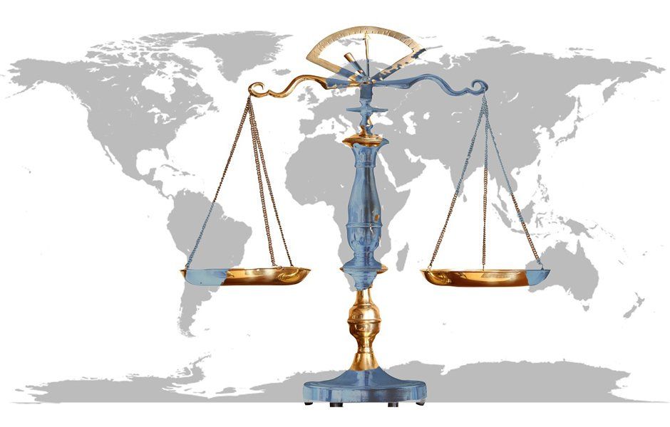balance scales in front of a world map