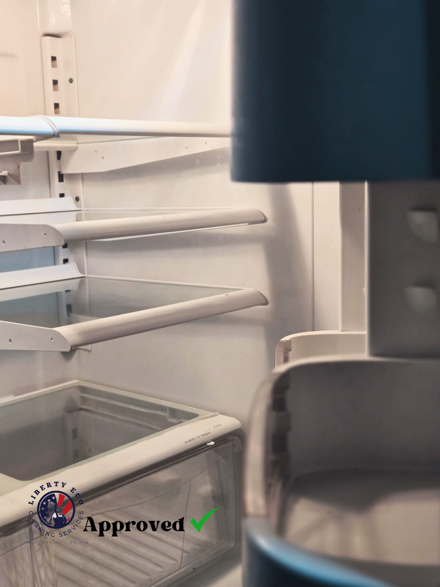 Empty refrigerator with shelves and a clear crisper drawer.