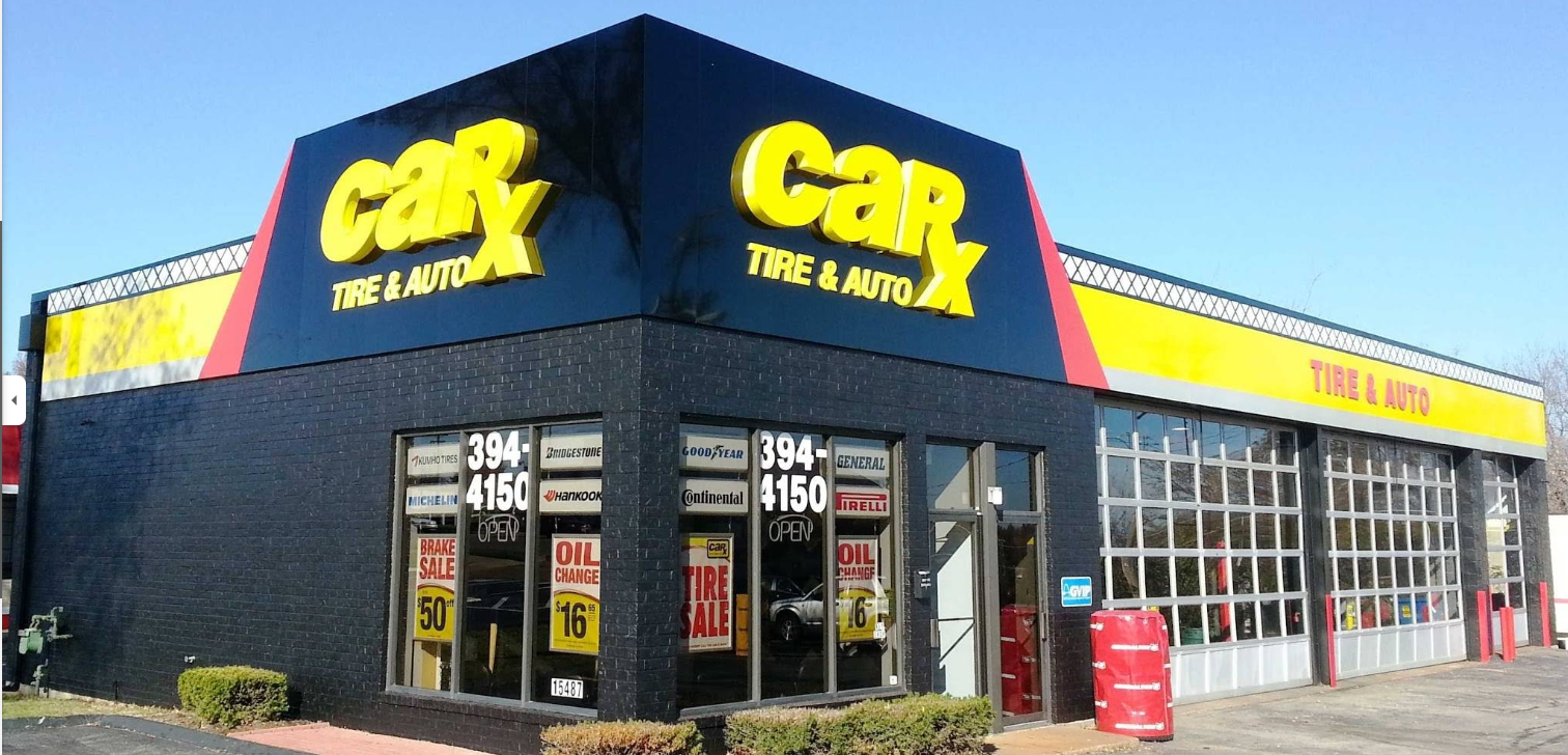 CarX Tire & Auto shop with yellow sign and red accents, on a sunny day.