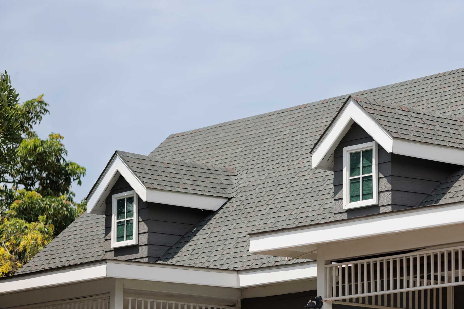 There are two windows on the roof of a house.