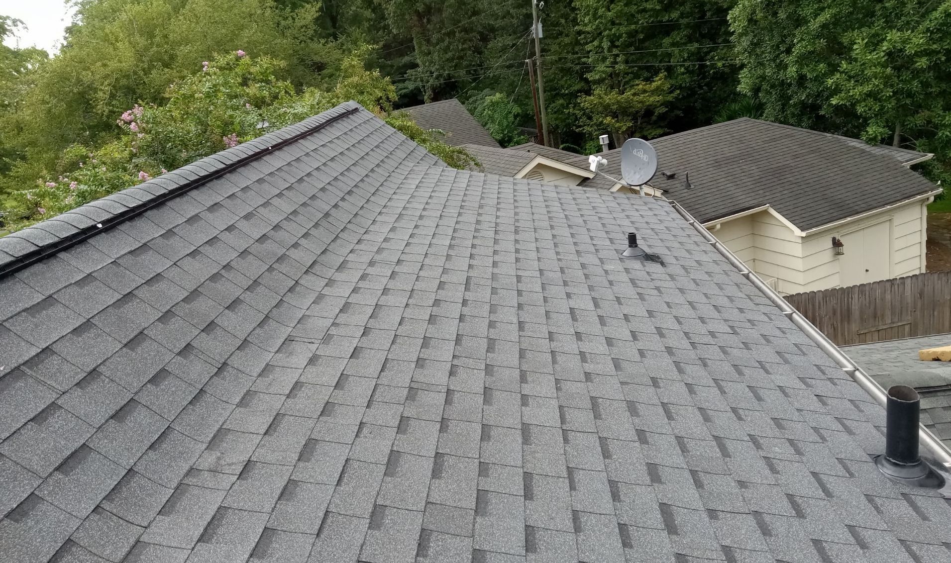 The roof of a house with a satellite dish on it.