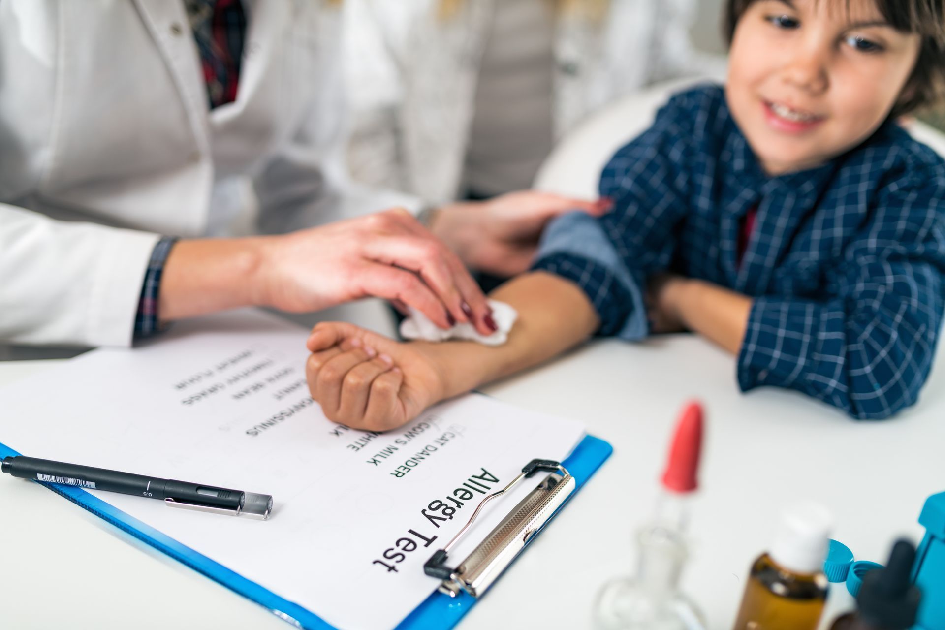 A doctor is doing a skin allergy test on a little boy. A doctor is doing a skin allergy test on a little boy.