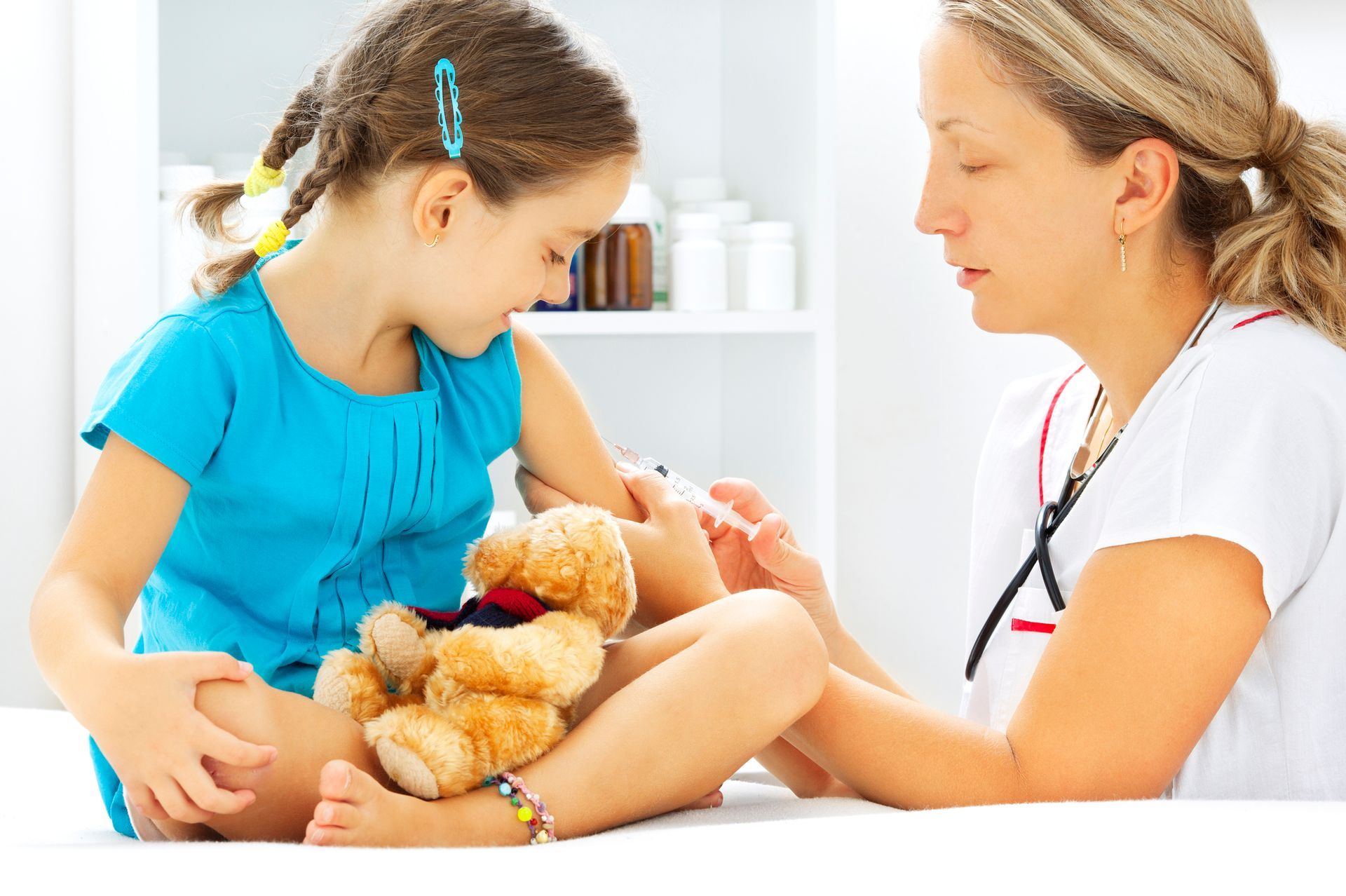 A healthcare professional provides a vaccination to a child, emphasizing the importance of immunizat