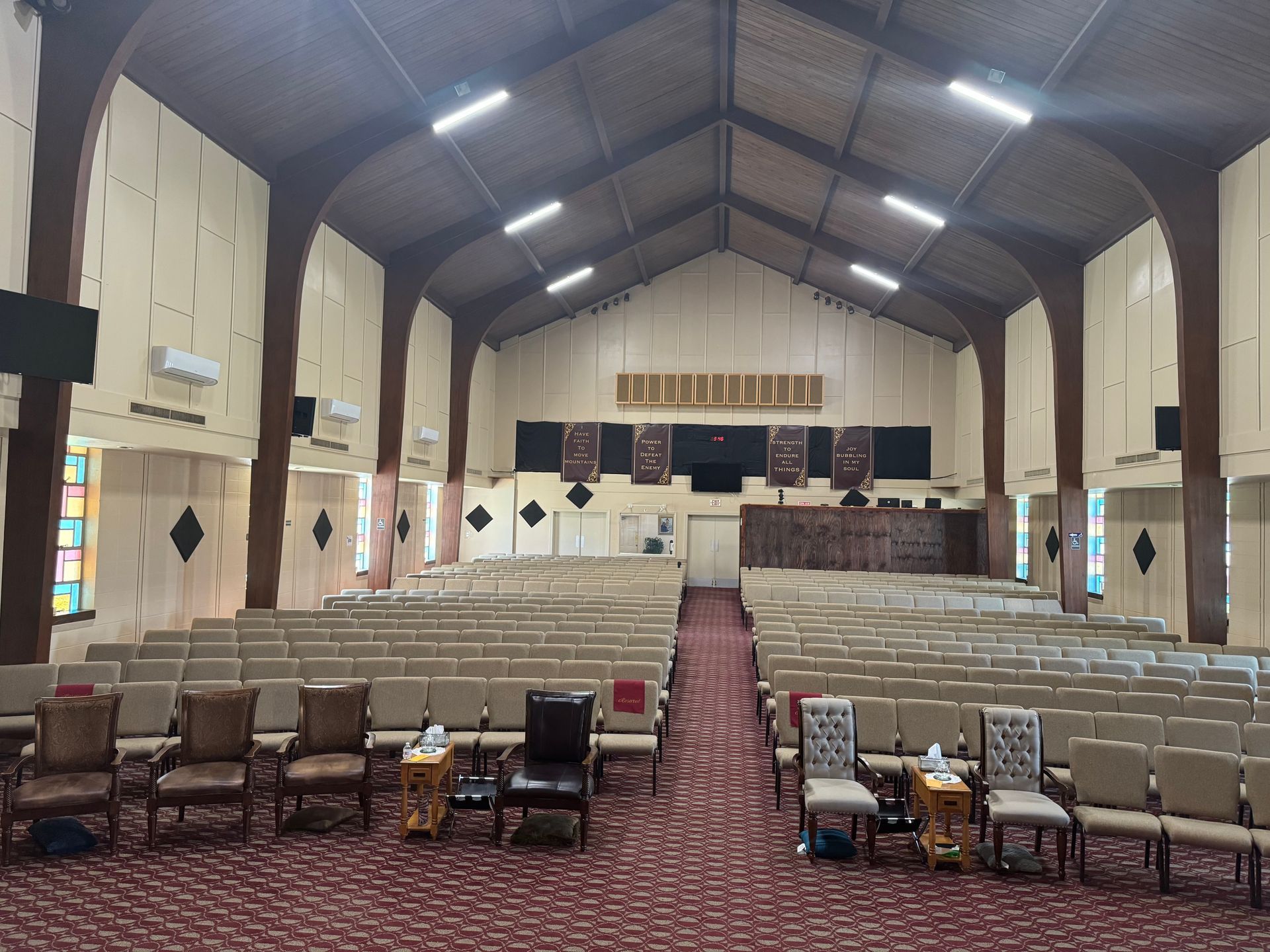 The convention center auditorium is large and spacious with seating for 400 guests. There is a media booth in the back that controls the large screen displays and audio system. 