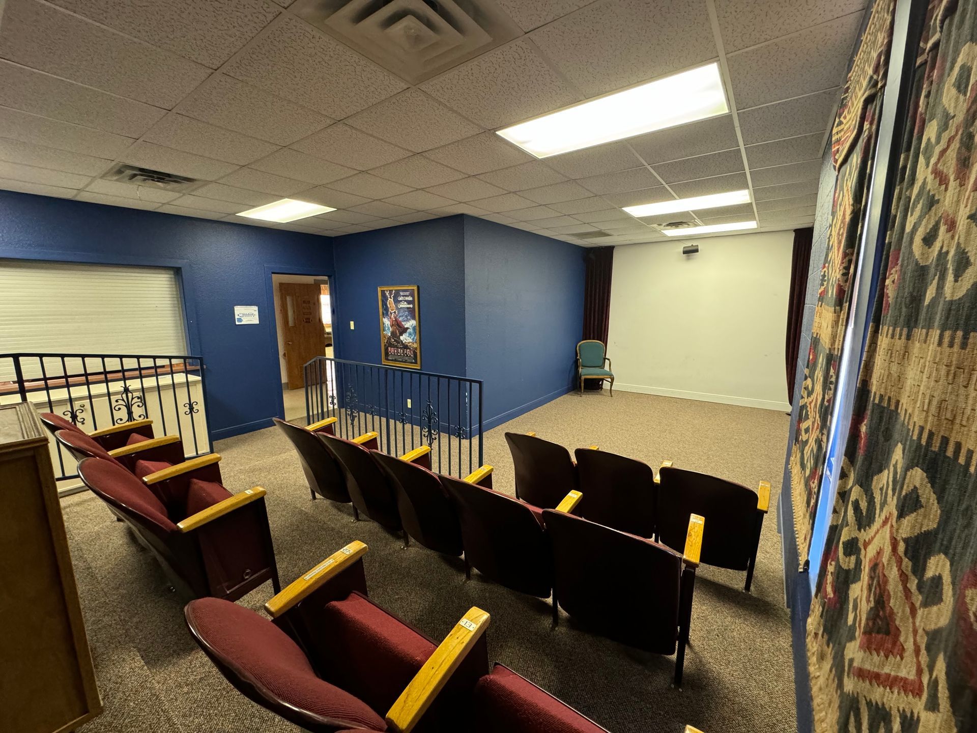 Convention center movie theater room with seats for 19 people. Movies can be viewed with the projector onto the wall. 