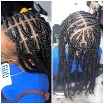 Two women with braided hairstyles; one left, wearing blue; one right, also blue, in a chair.