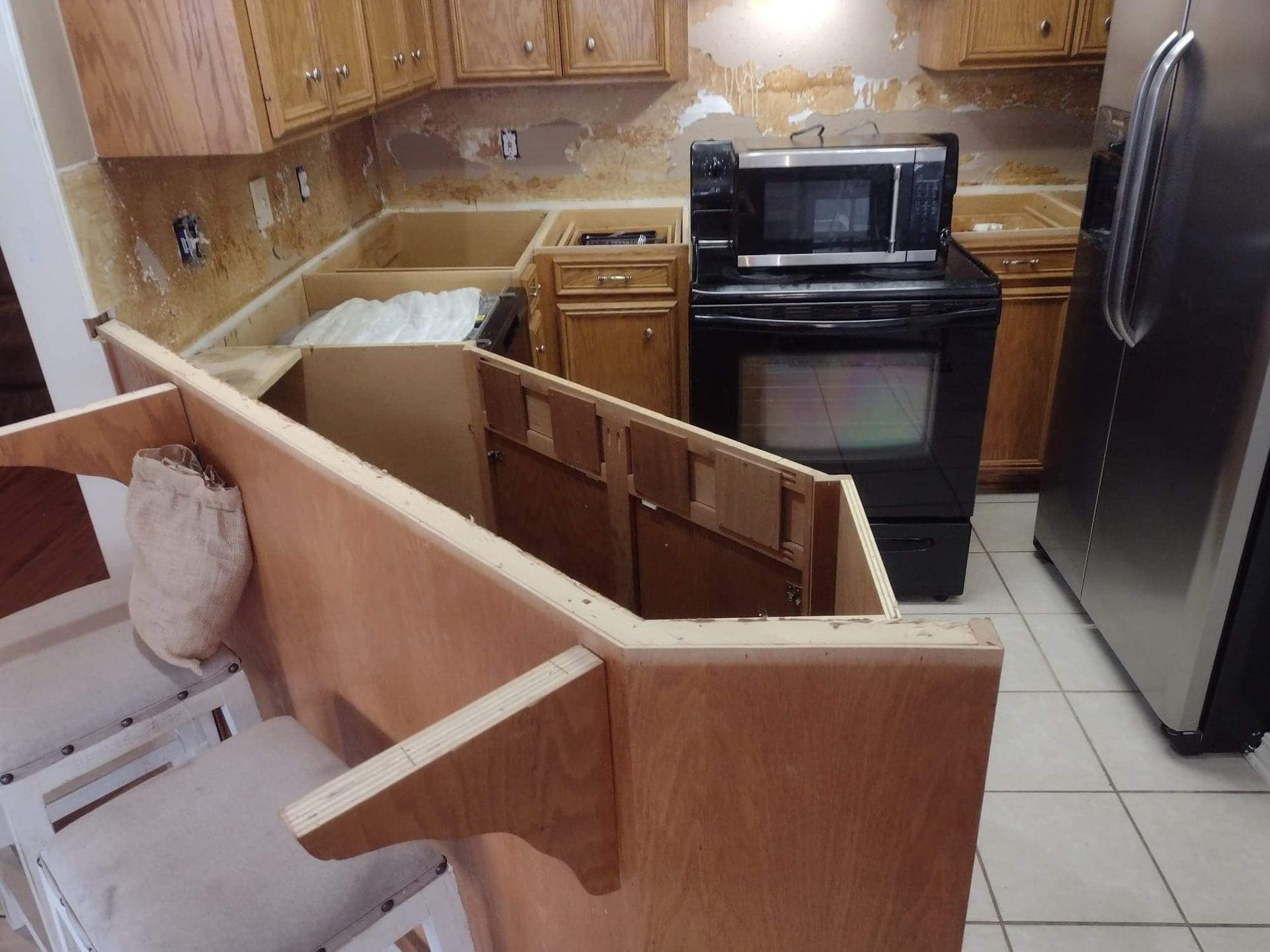 A kitchen with a stove a microwave and a refrigerator