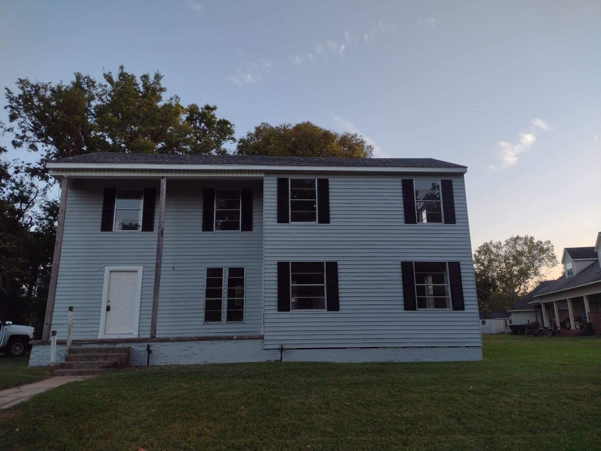 A white house with black shutters on the windows