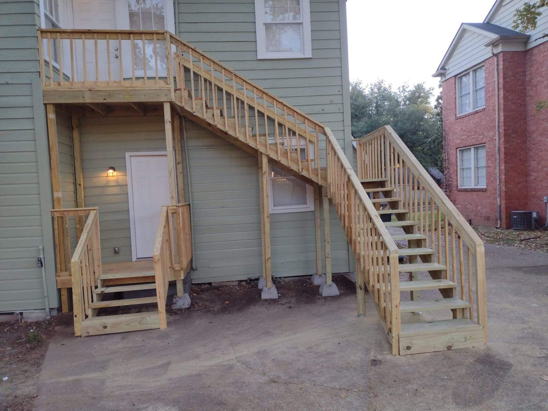 A house with wooden stairs leading up to the second floor