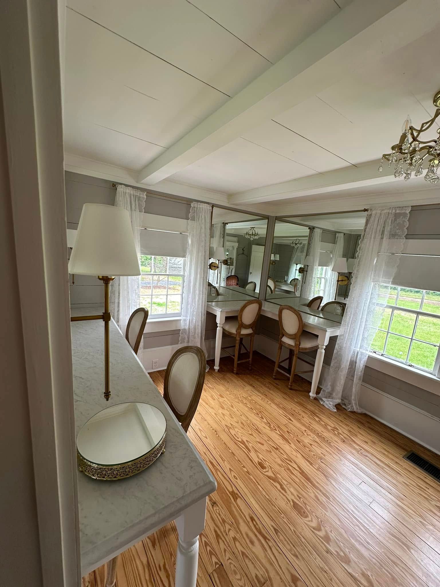 A large room with wooden floors and a lot of mirrors.