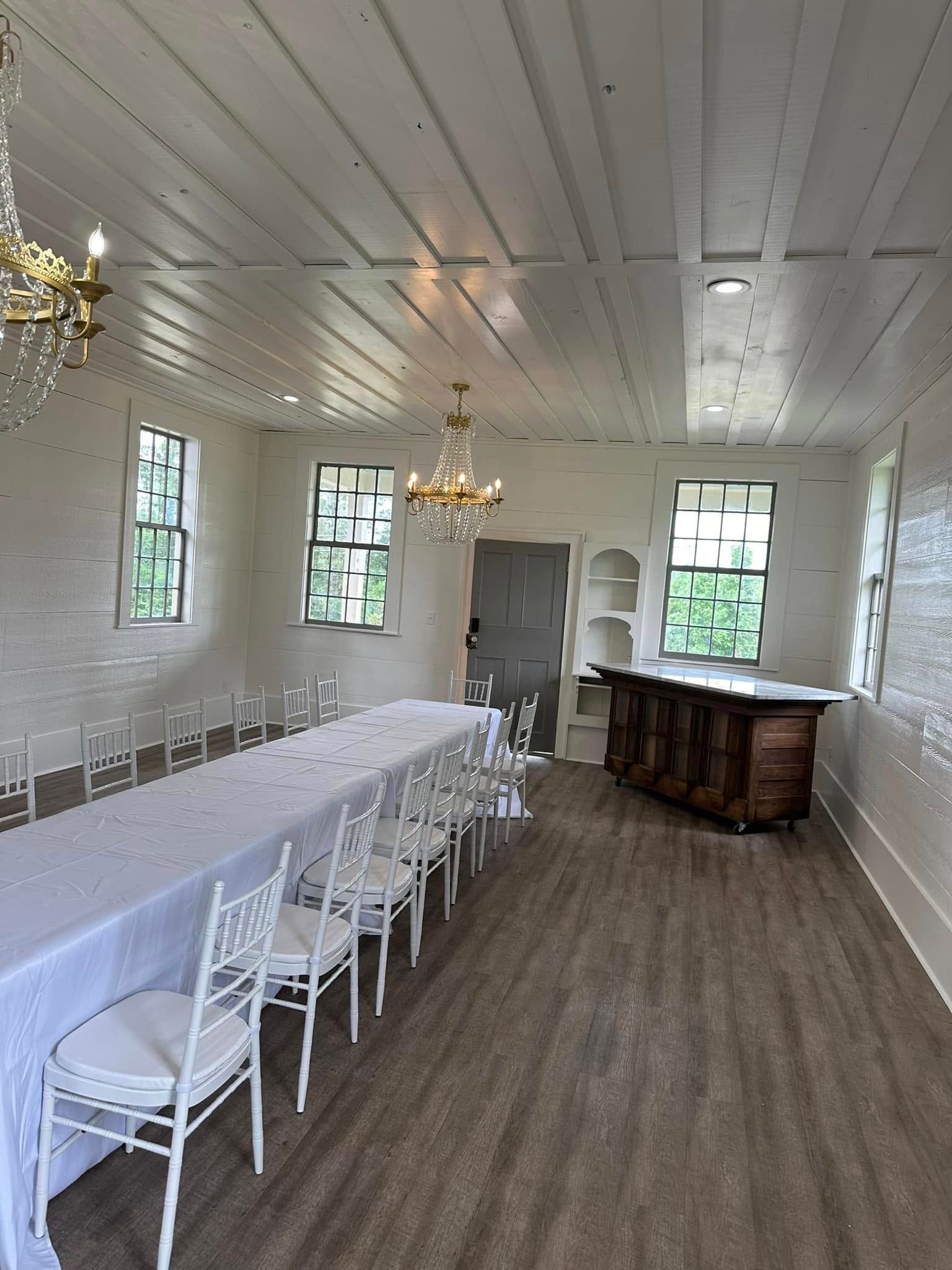 There is a long table and chairs in the room.