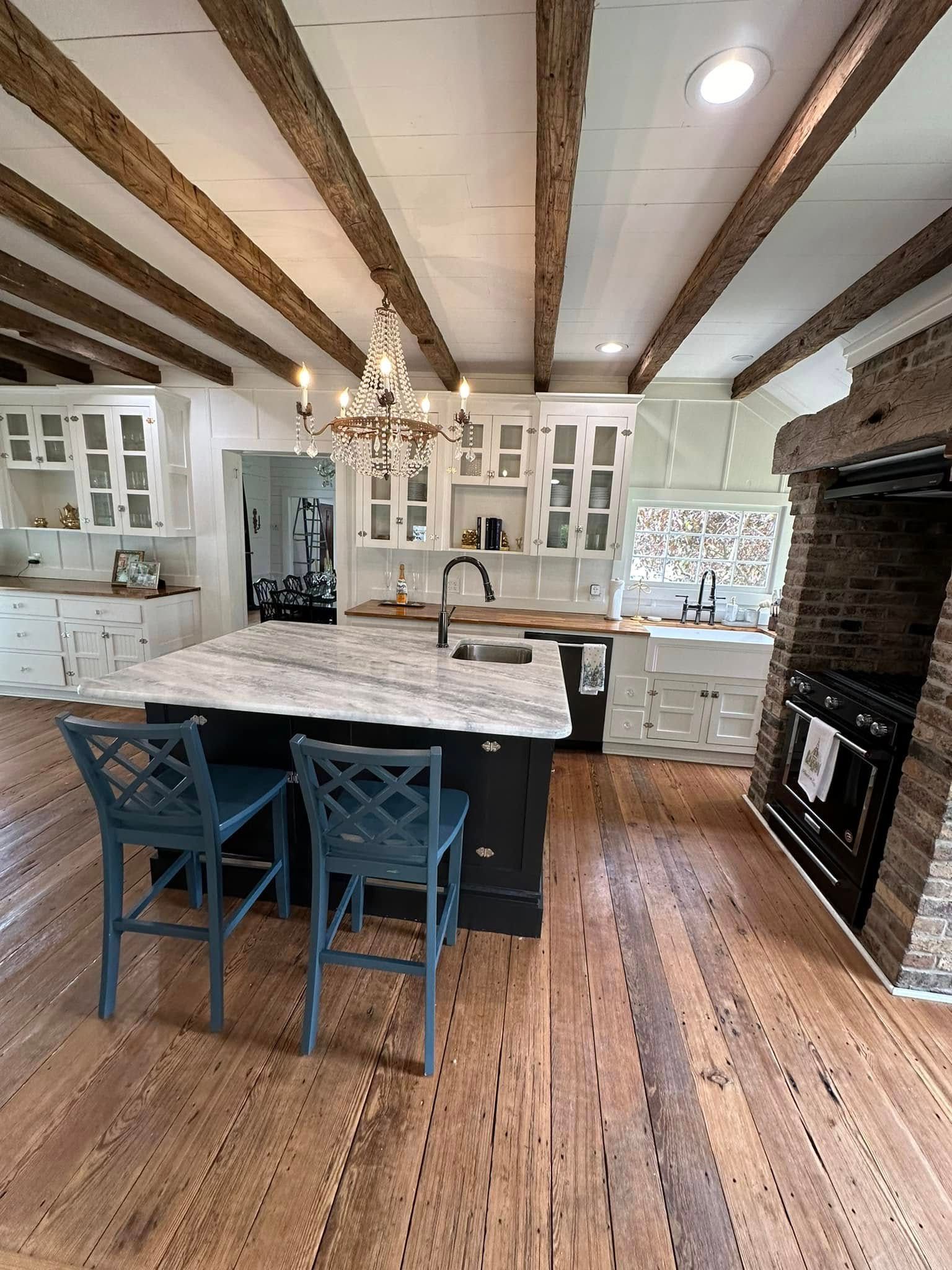 A kitchen with a large island in the middle and a fireplace.