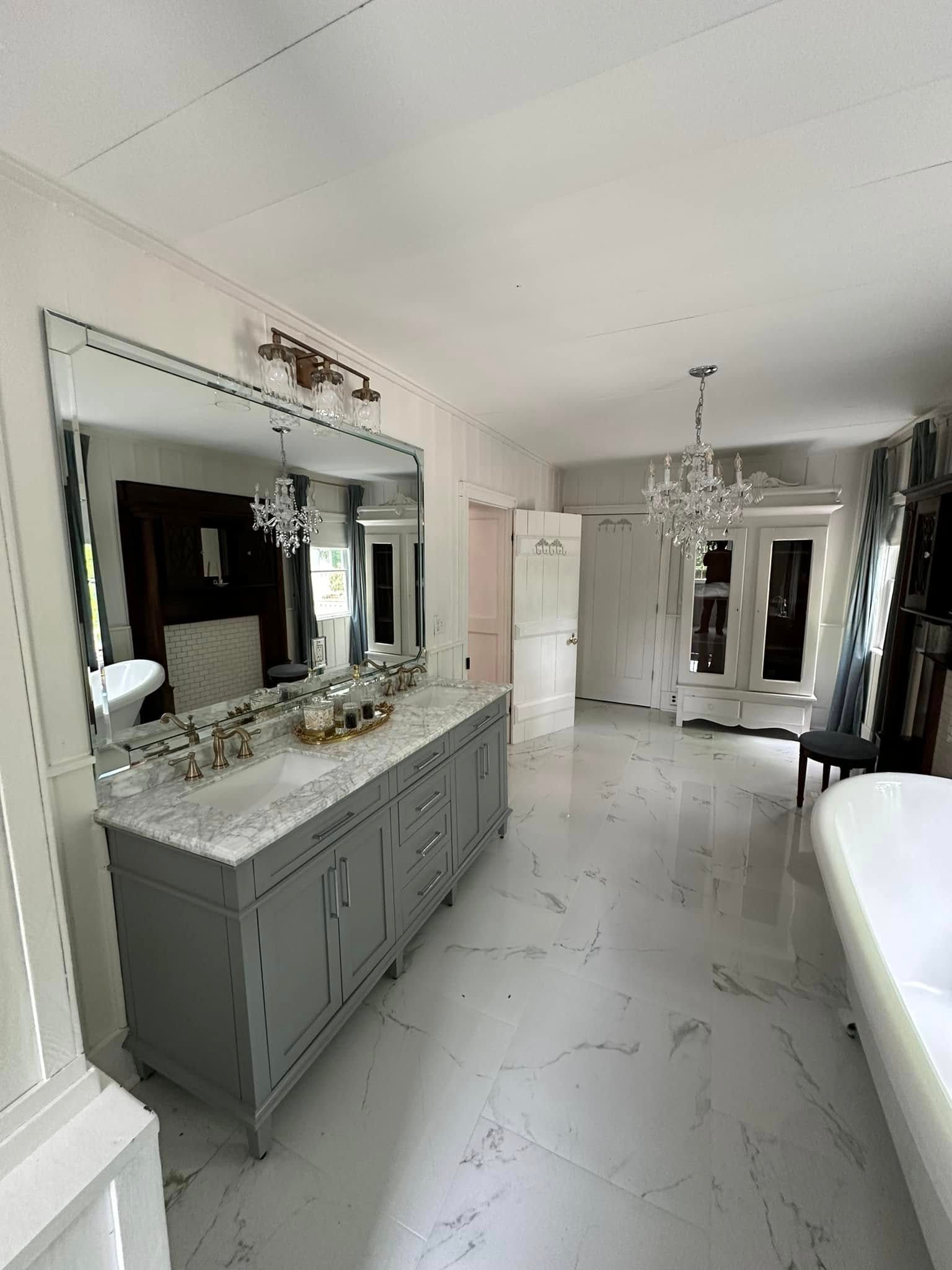 A bathroom with two sinks , a large mirror and a bathtub.