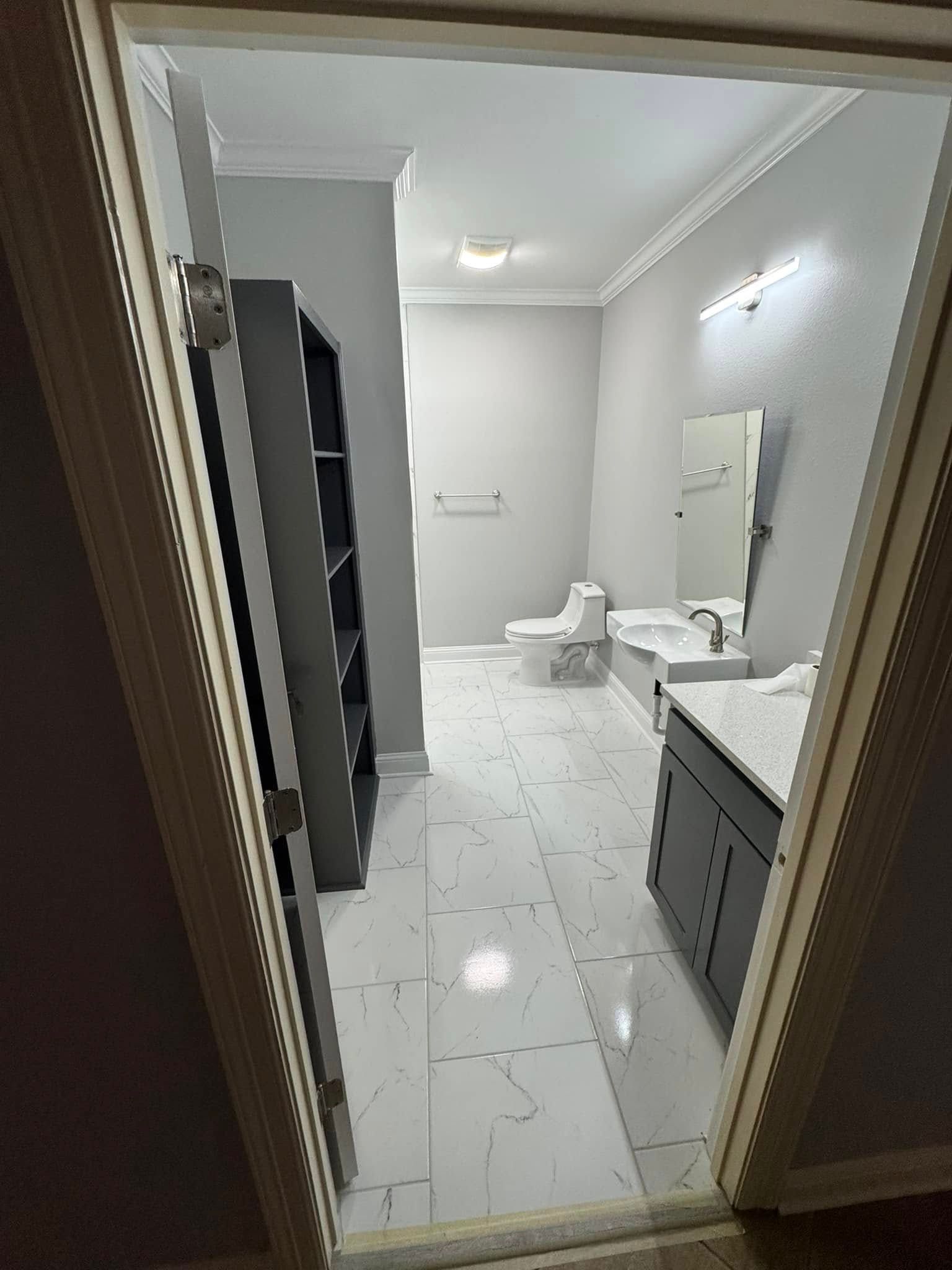 A bathroom with a toilet , sink , mirror and bathtub.
