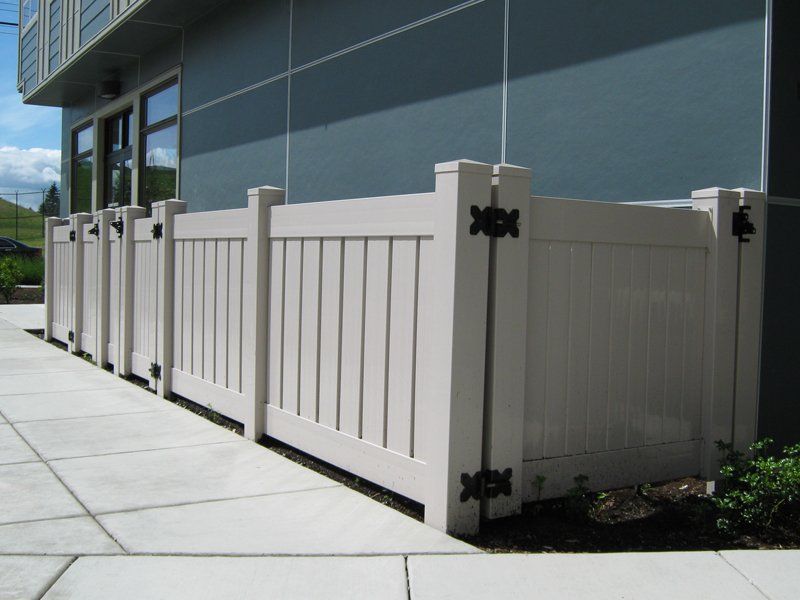 White  Fence and Gray House — Auburn, WA — Rainier Fencing & Decking